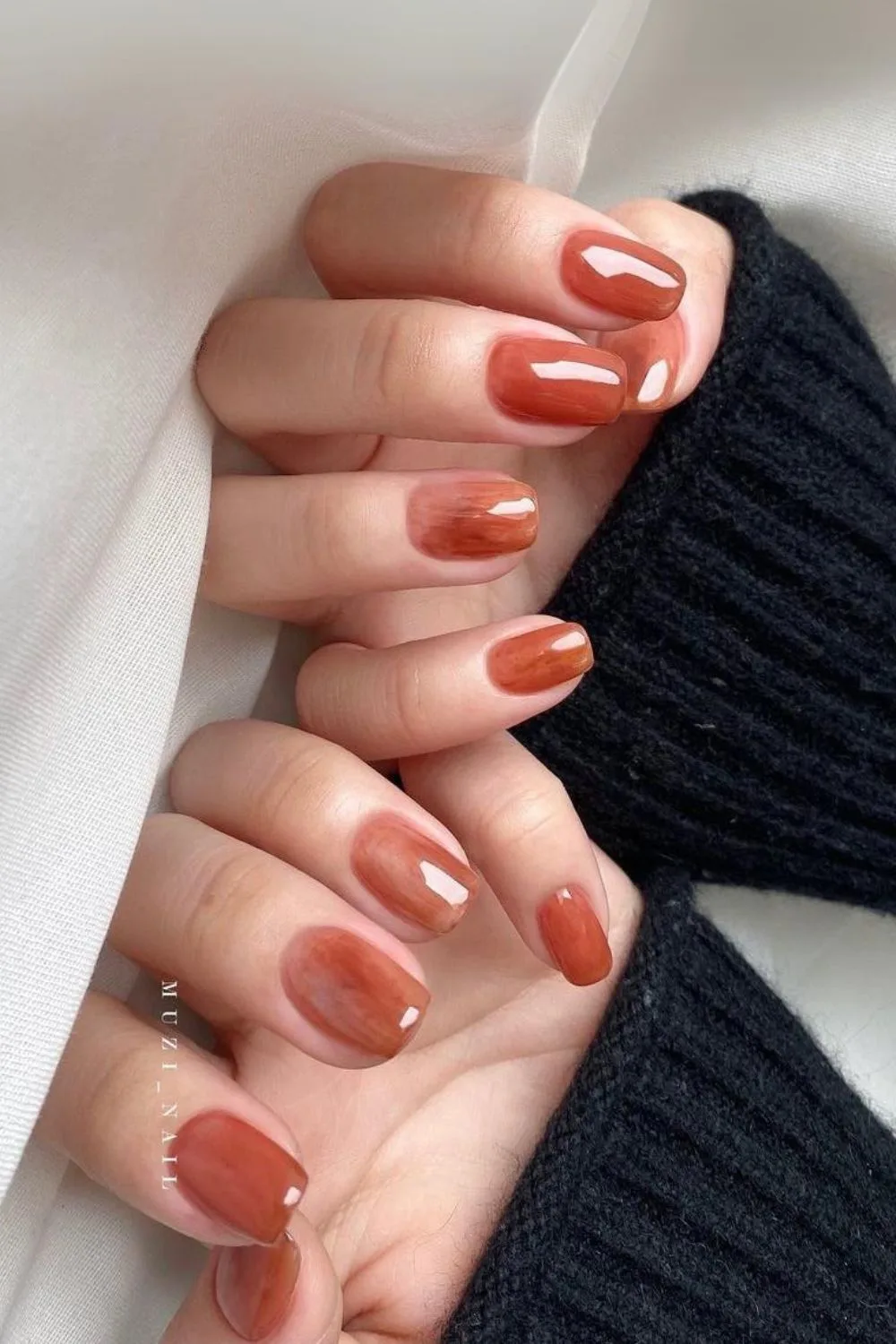 Burnt orange jelly nails with subtle marbling