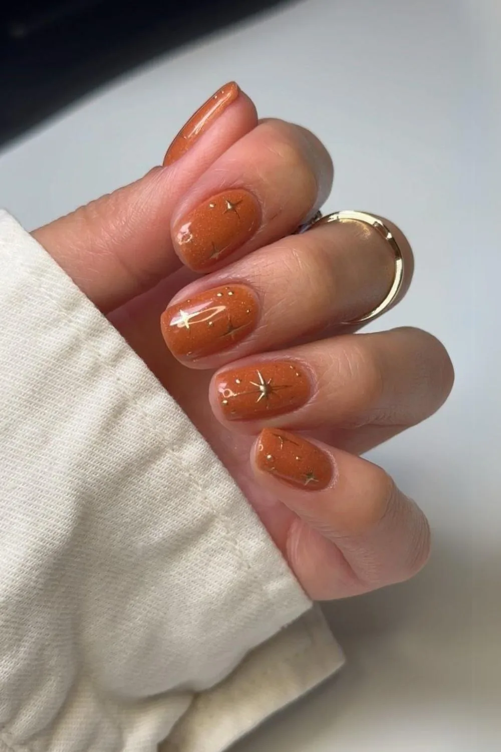 Burnt orange nails with chrome stars