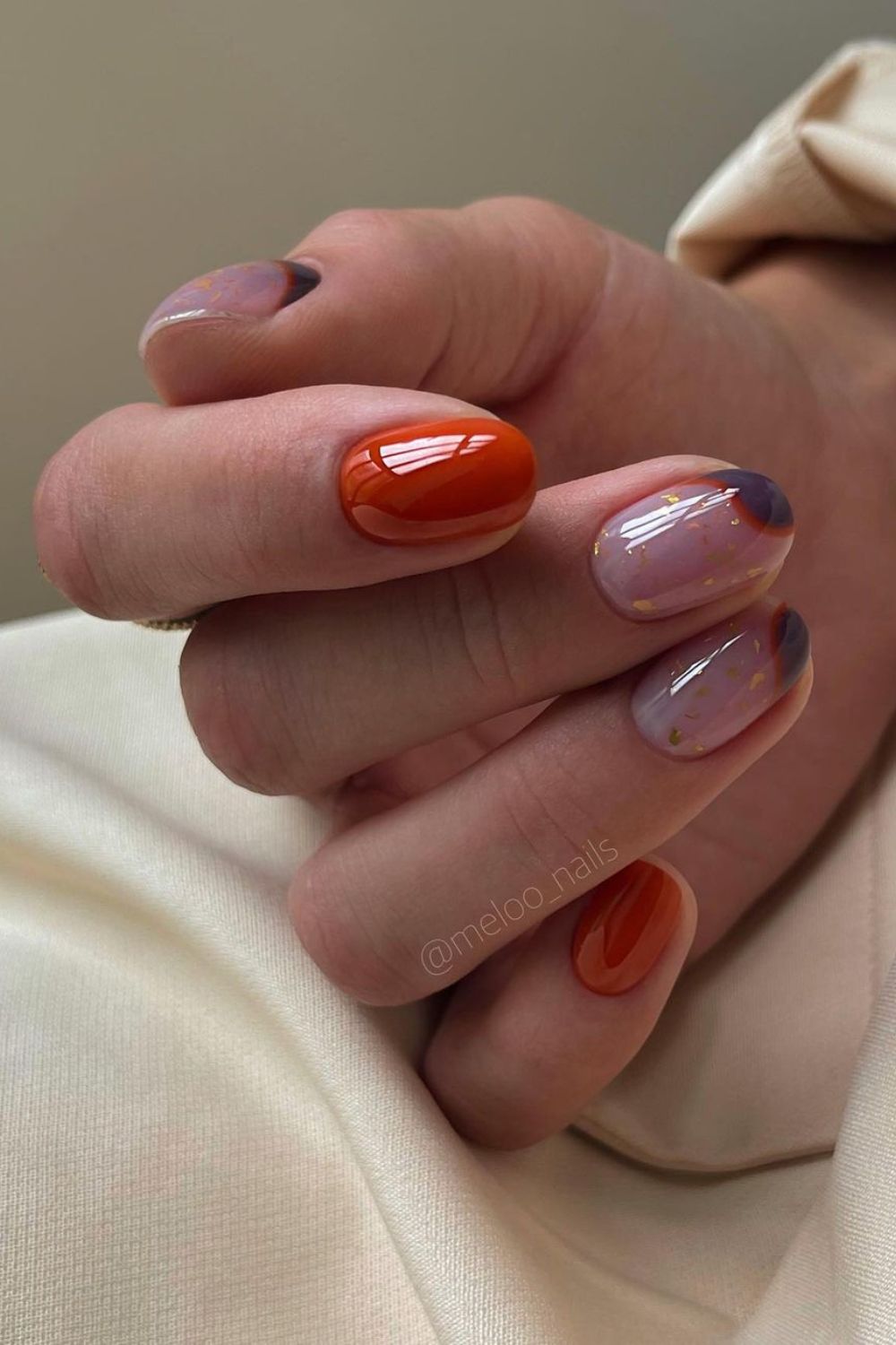 Burnt orange nails with dark purple accents