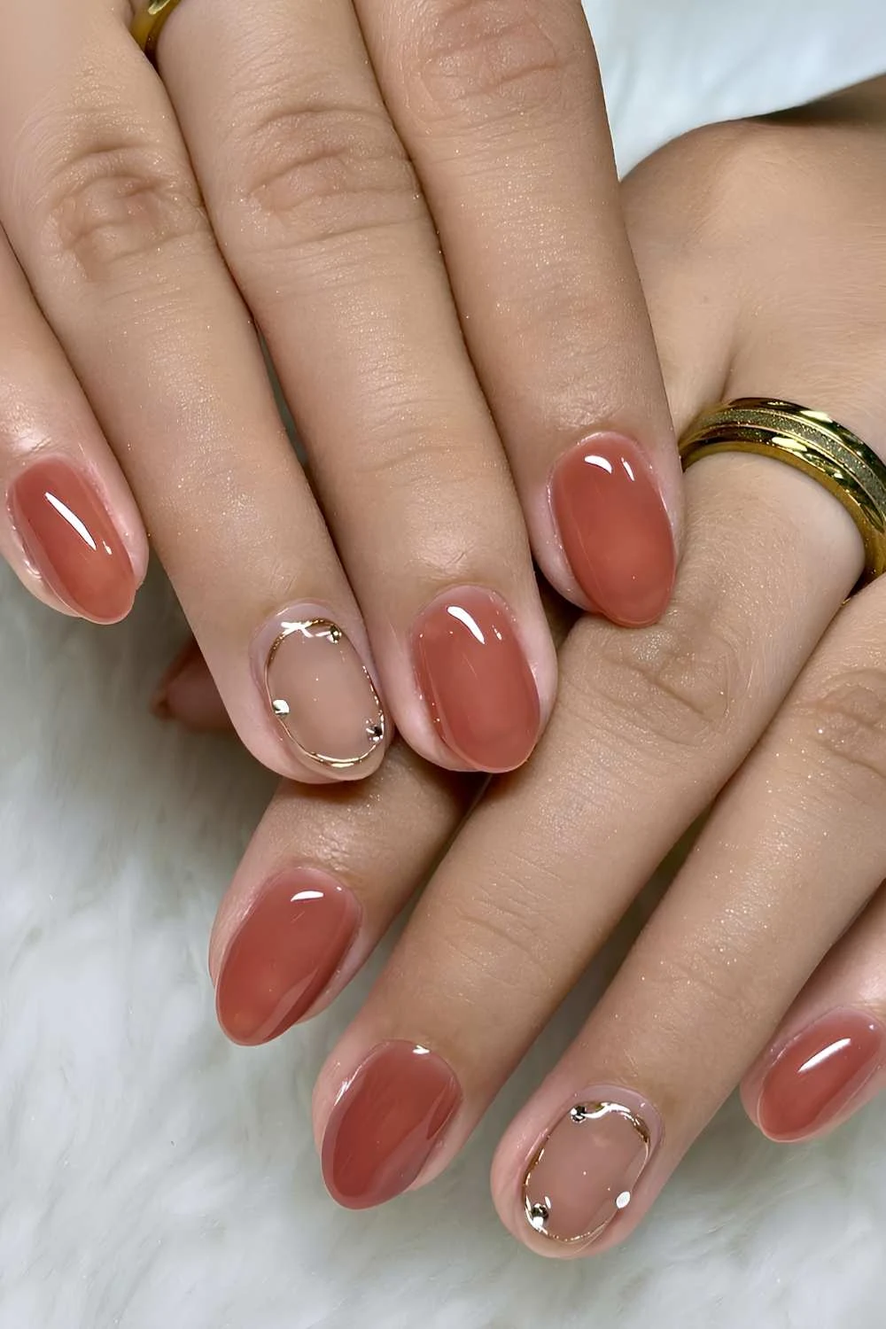 Burnt orange nails with metallic accents