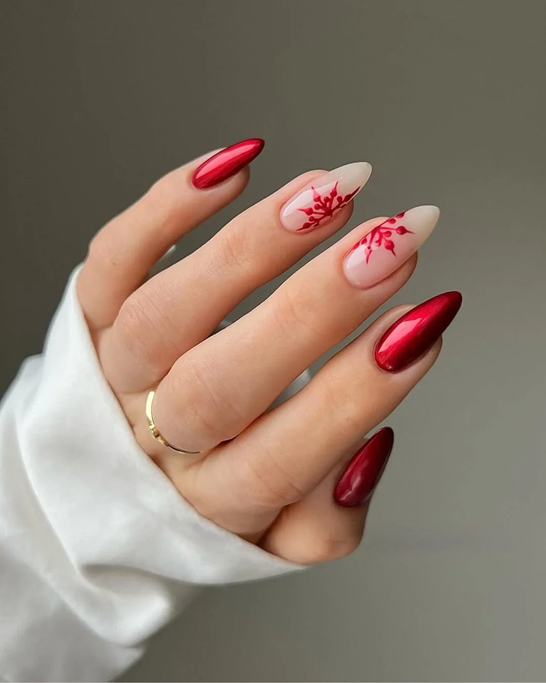 Cherry red and nude nails with cherry red snowflake details