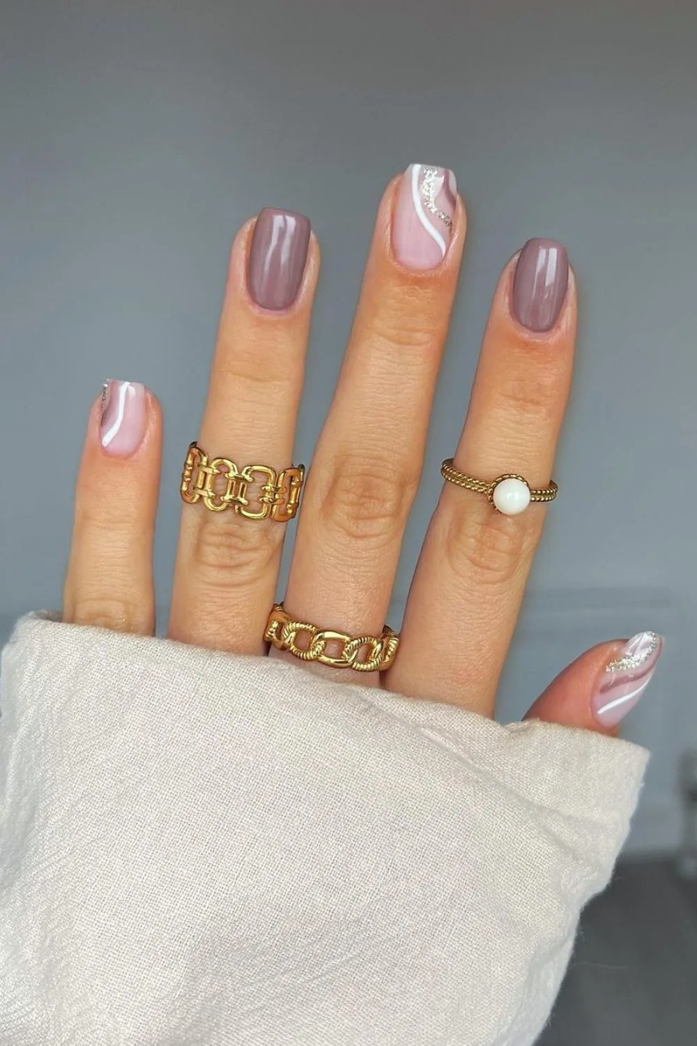 Cool-toned mauve nails with swirls