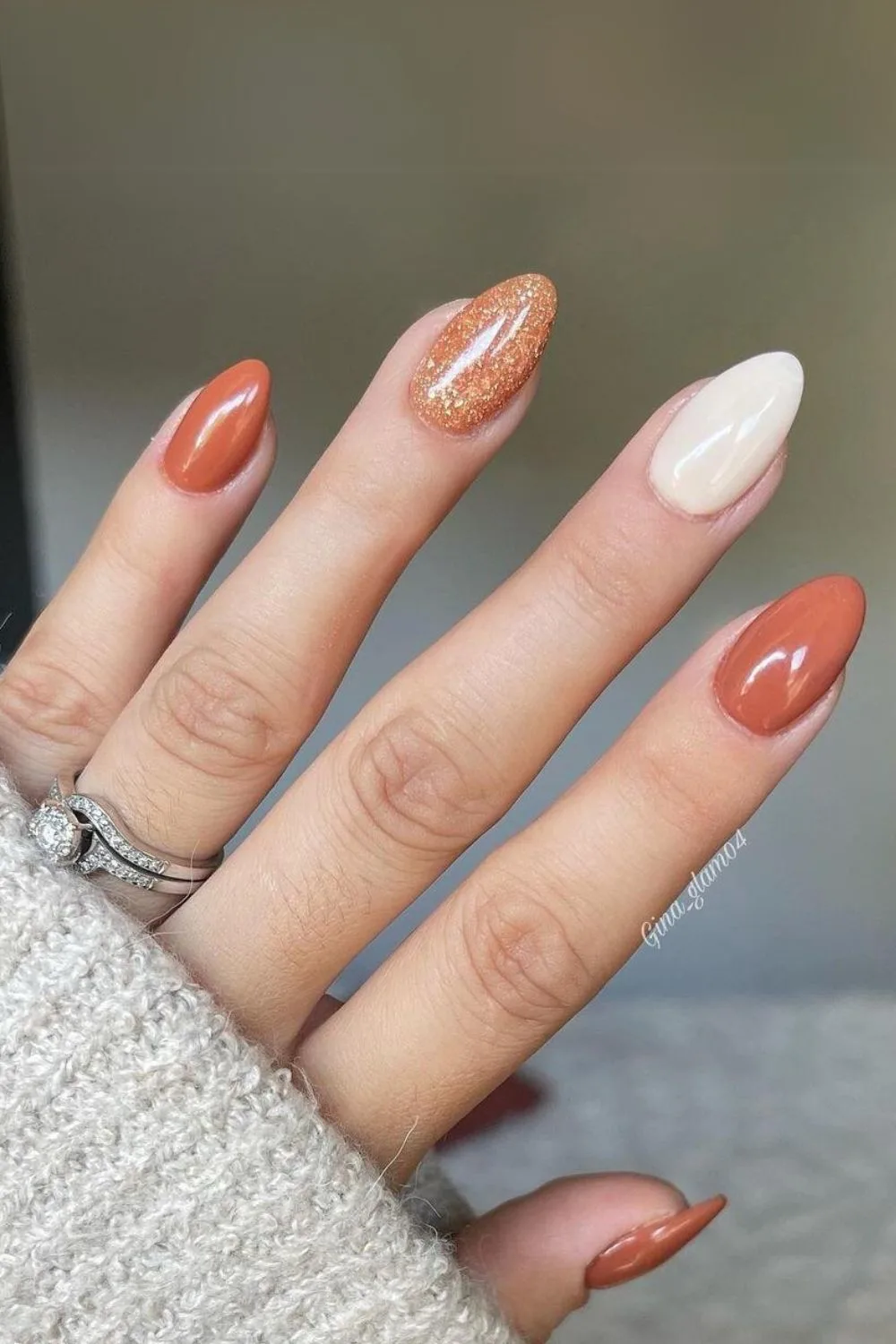 Copper orange nails with beige and glitter accents