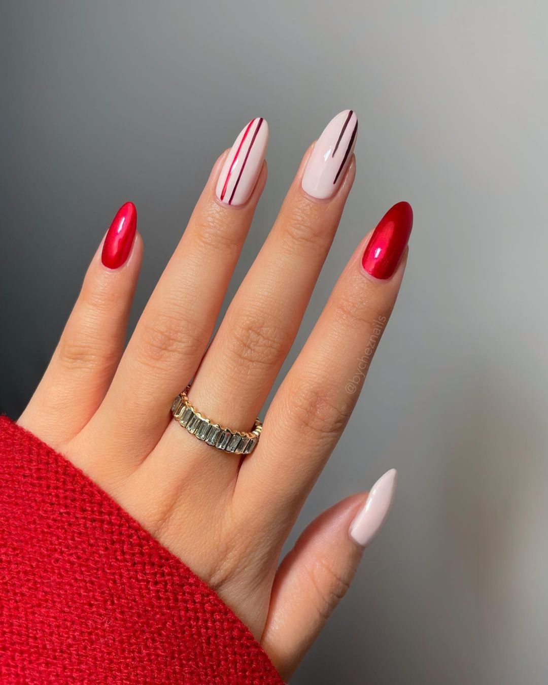 Crimson red and nude nails with vertical line accents