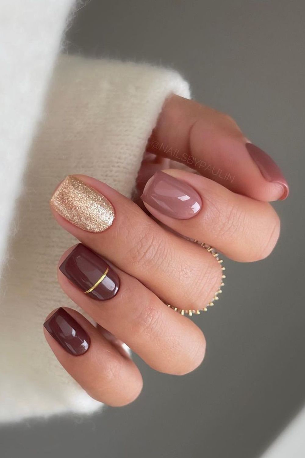 Dark and light mauve nails with gold accents