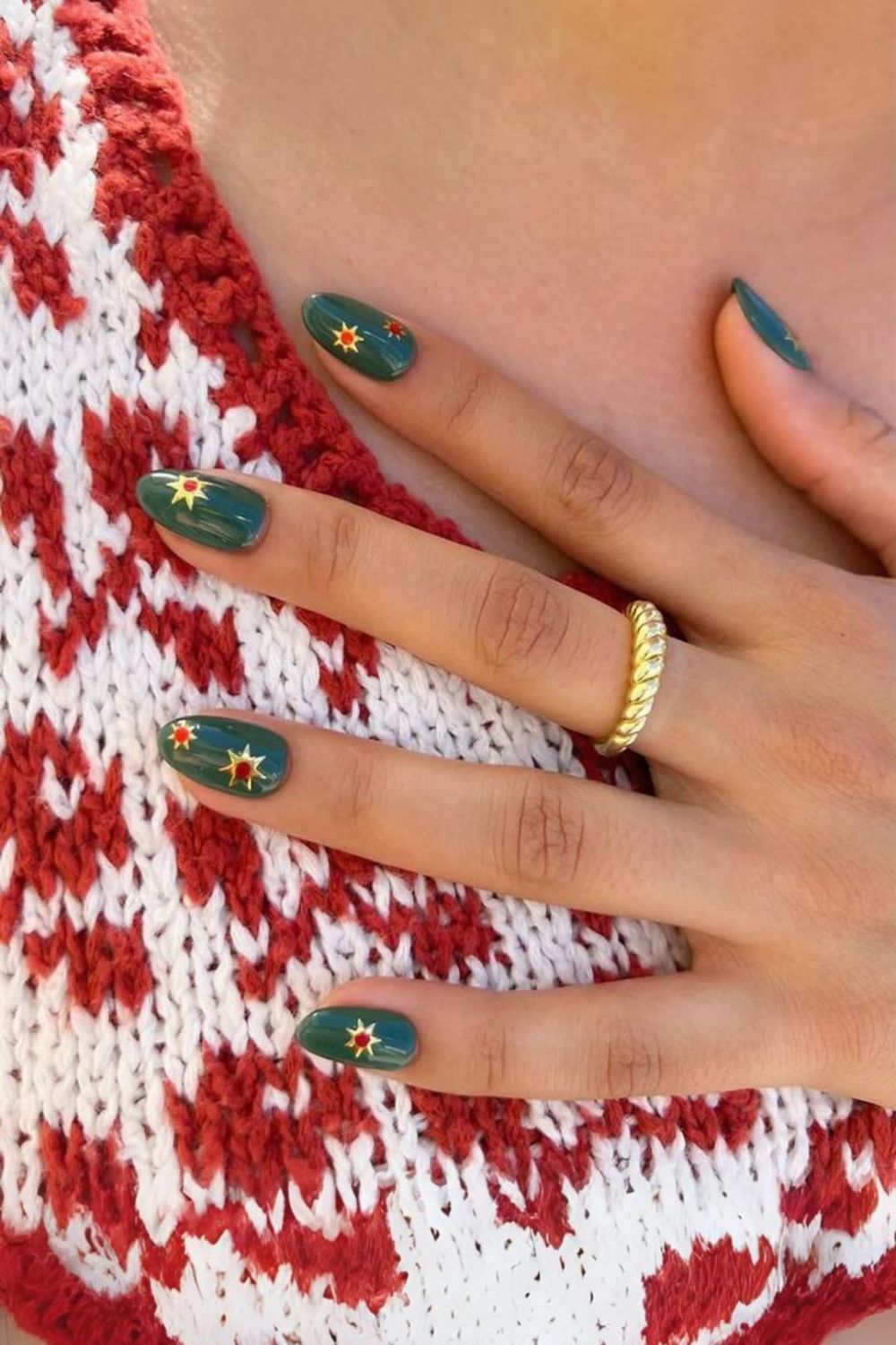 Dark green nails with gold sun charms