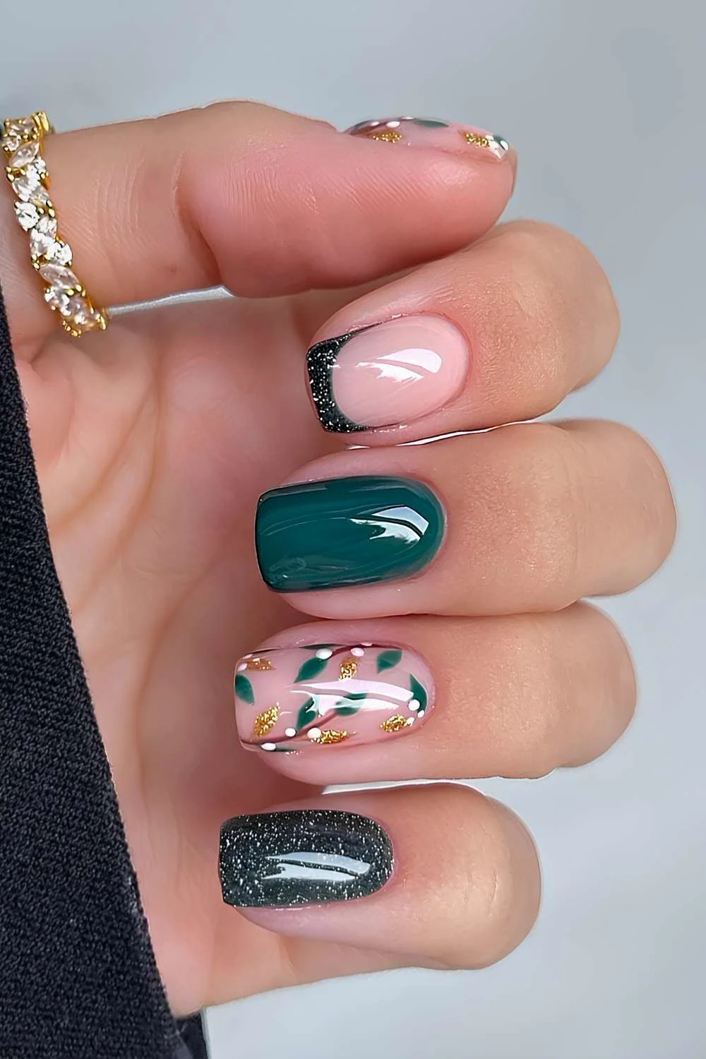 Dark green nails with mistletoe art and glitter