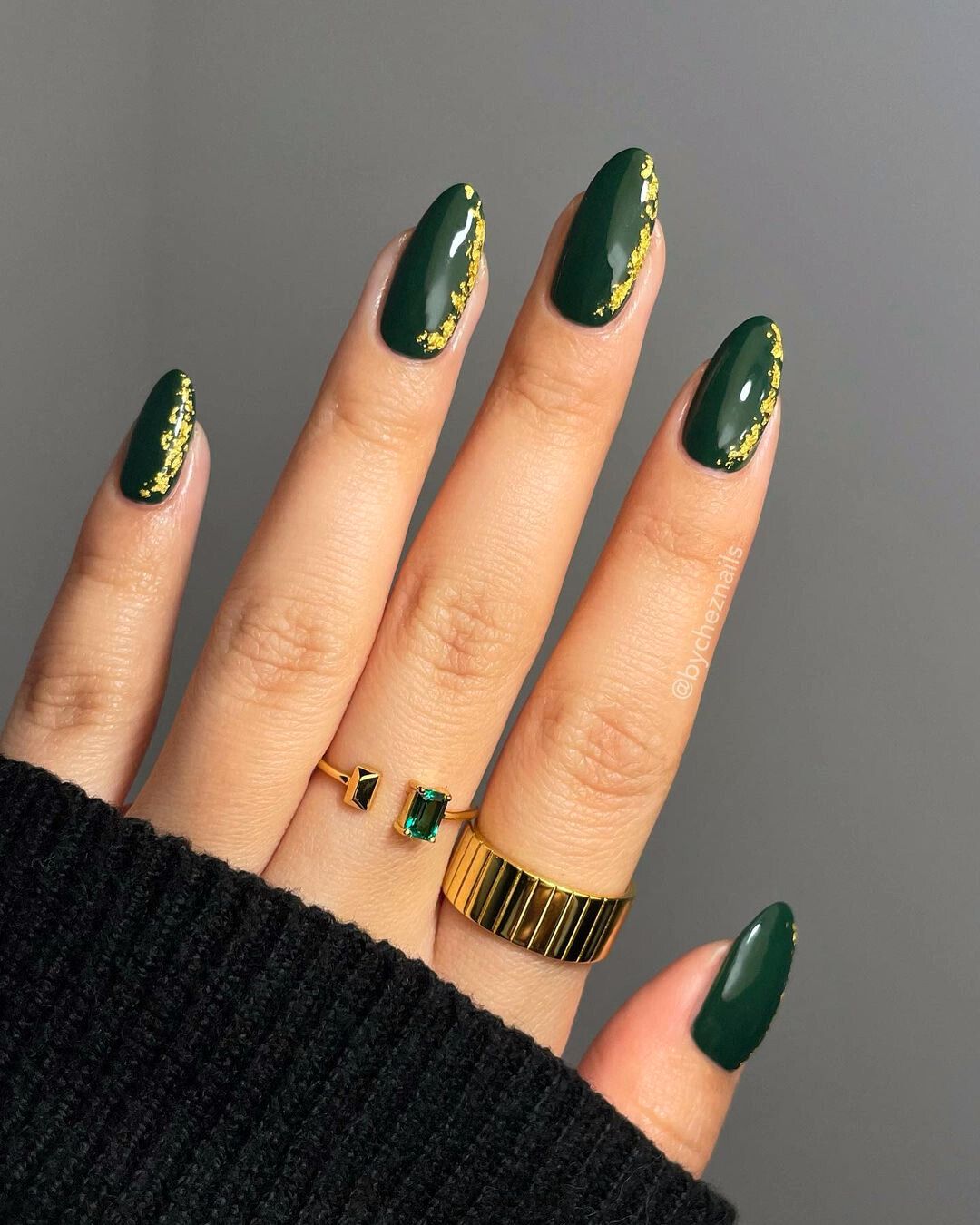 Deep green nails with gold accents