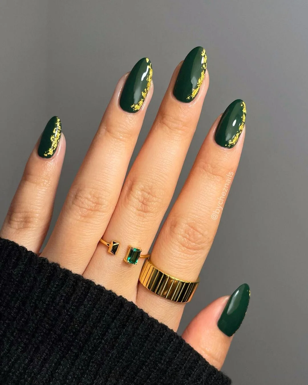 Deep green nails with gold accents