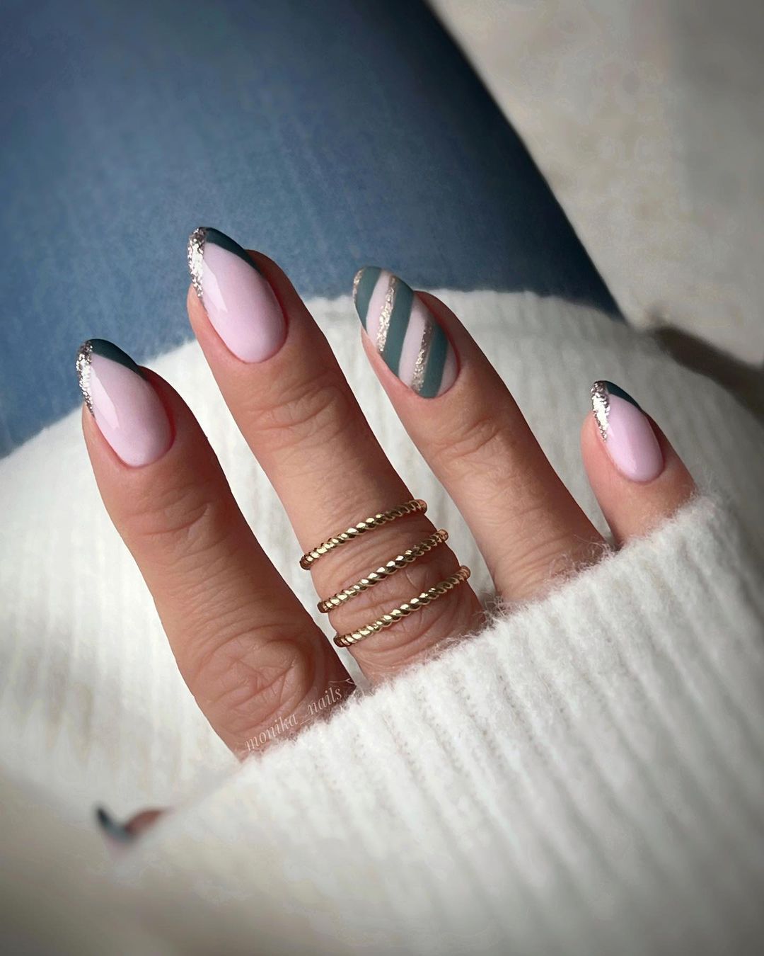 Delicate pink nails with deep forest green and gold motives