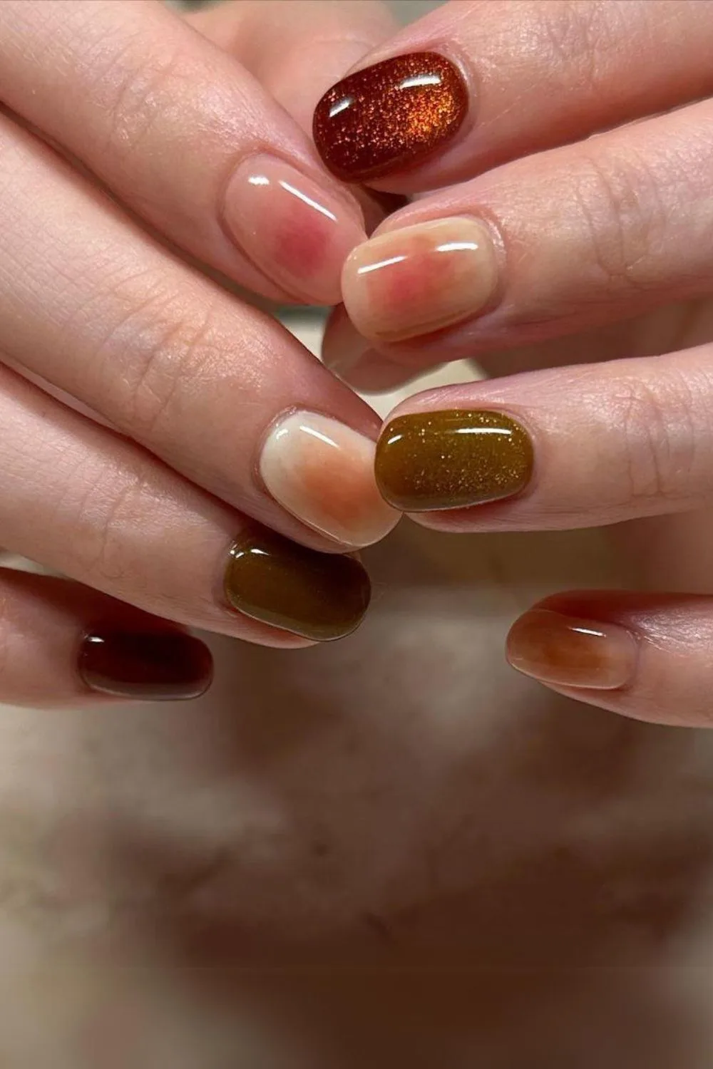 Earthy nails with cat-eye and aura effect