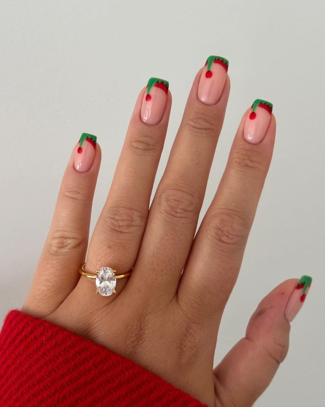 Elf hat french tips in green and red nail shades