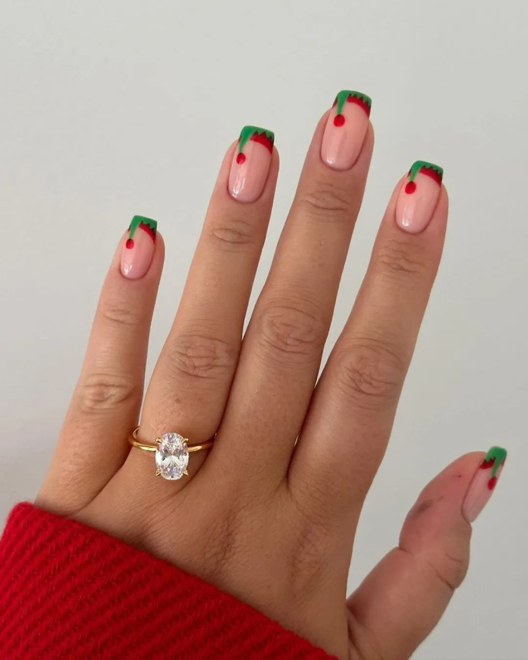 Elf hat french tips in green and red nail shades