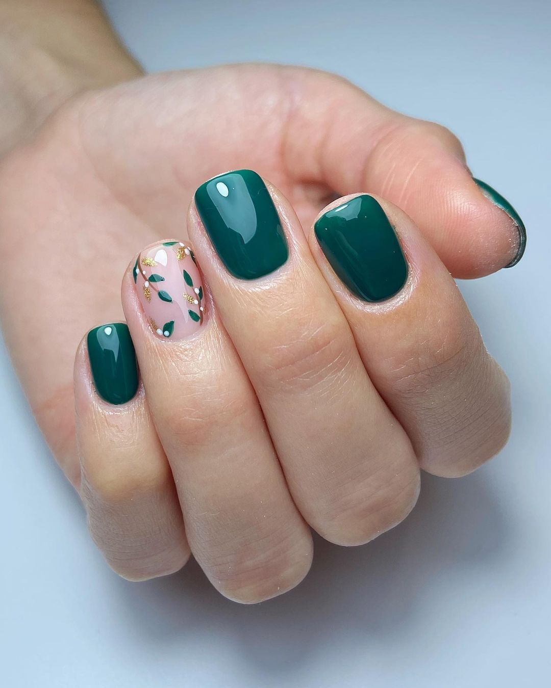 Emerald green nails with mistletoe accent nail