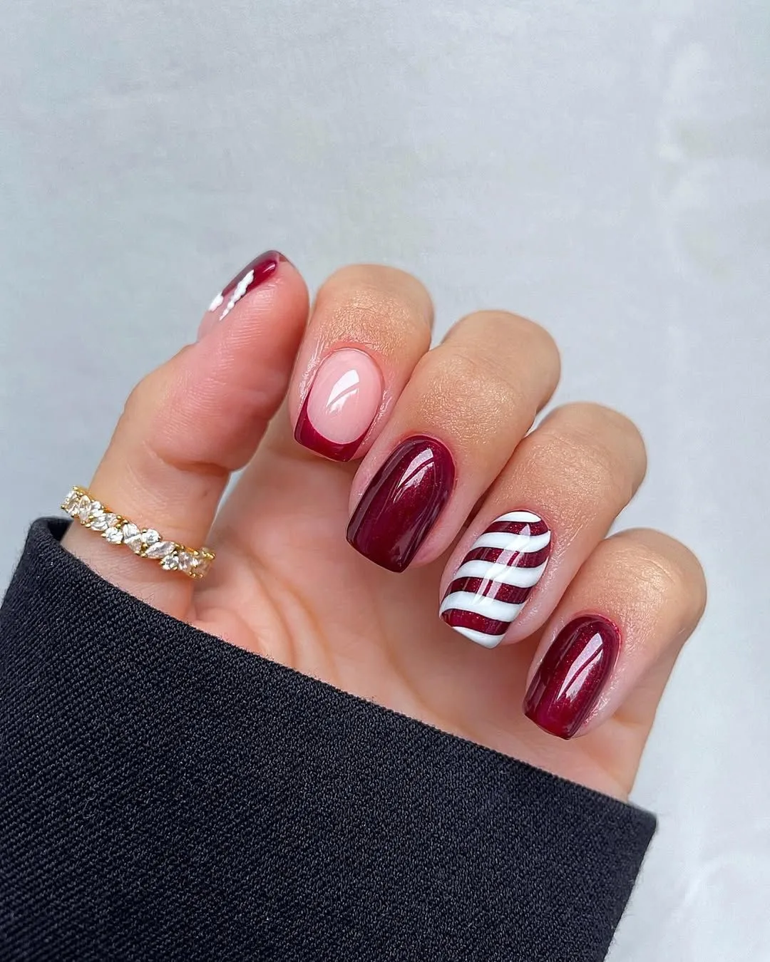 Glossy Burgundy nails with candy cane stripes accent