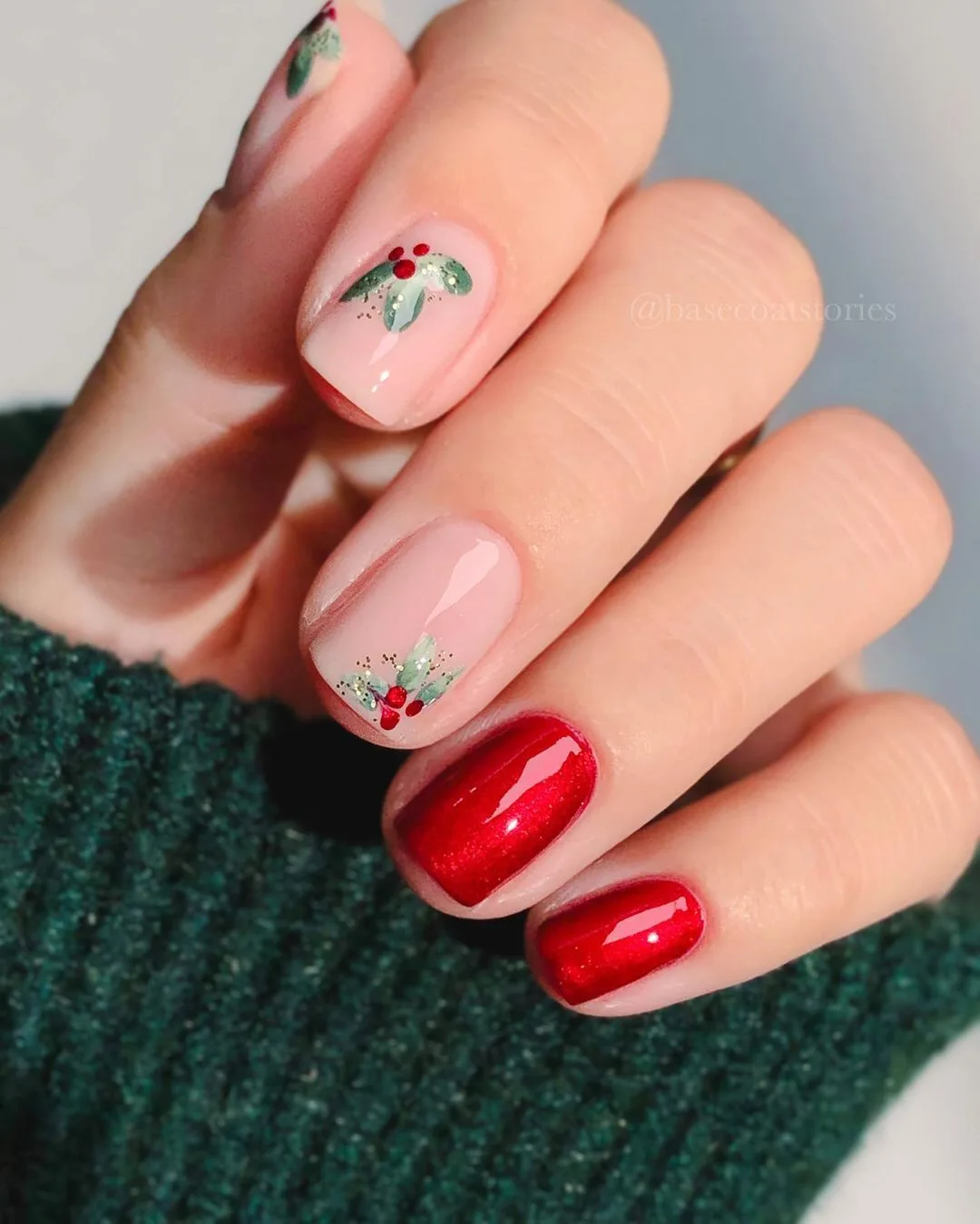 Glossy carmine red nails with mistletoe accents