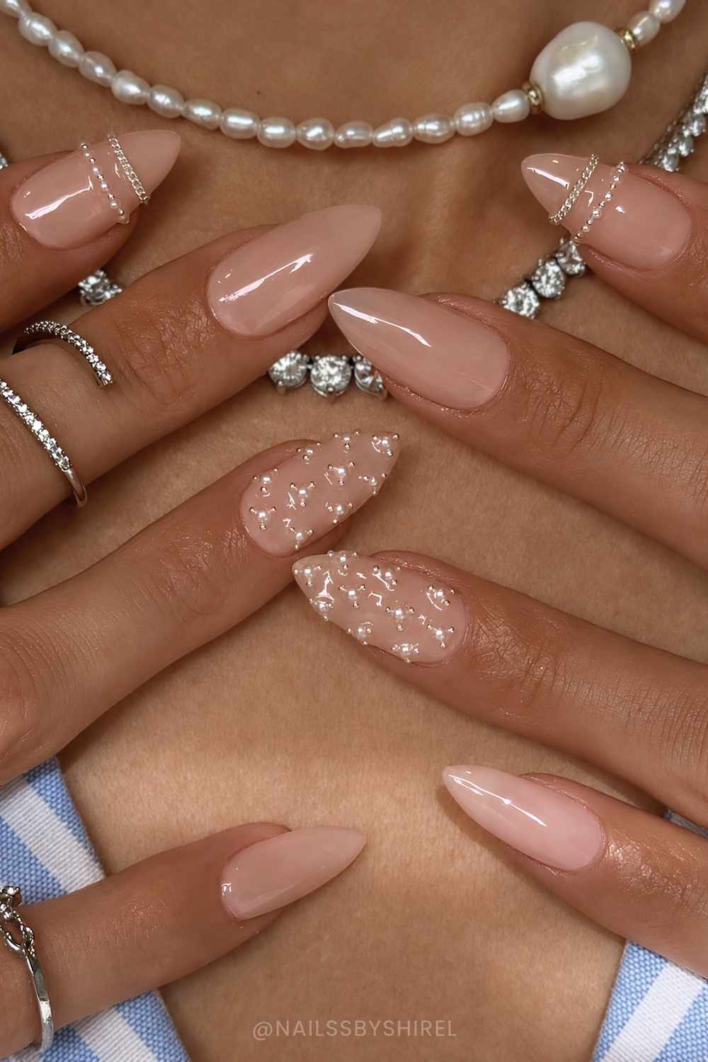 Glossy neutral nails with pearls and bangle art