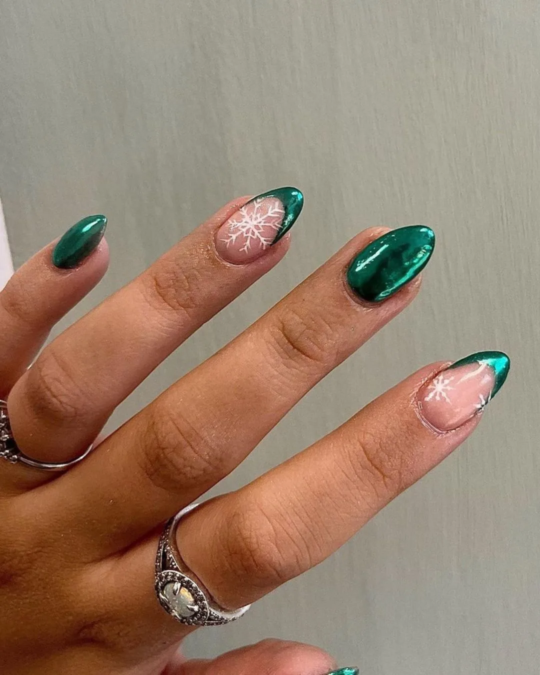 Green chrome nails with white snowflakes