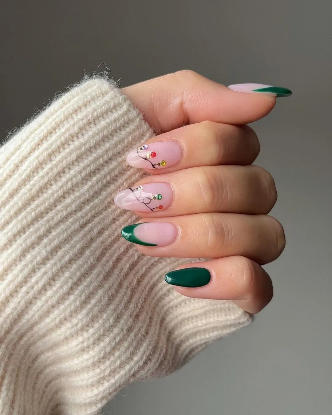 Green nails with Christmas lights design on two nude nails