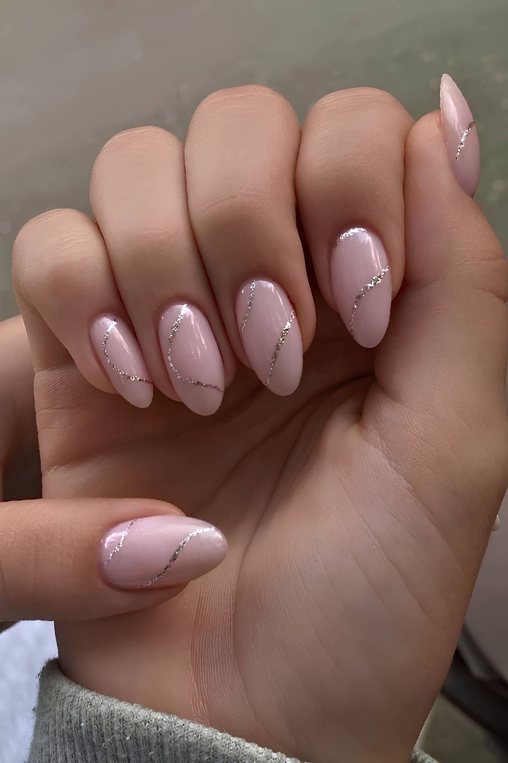 Milky pink nails with silver glitter lines