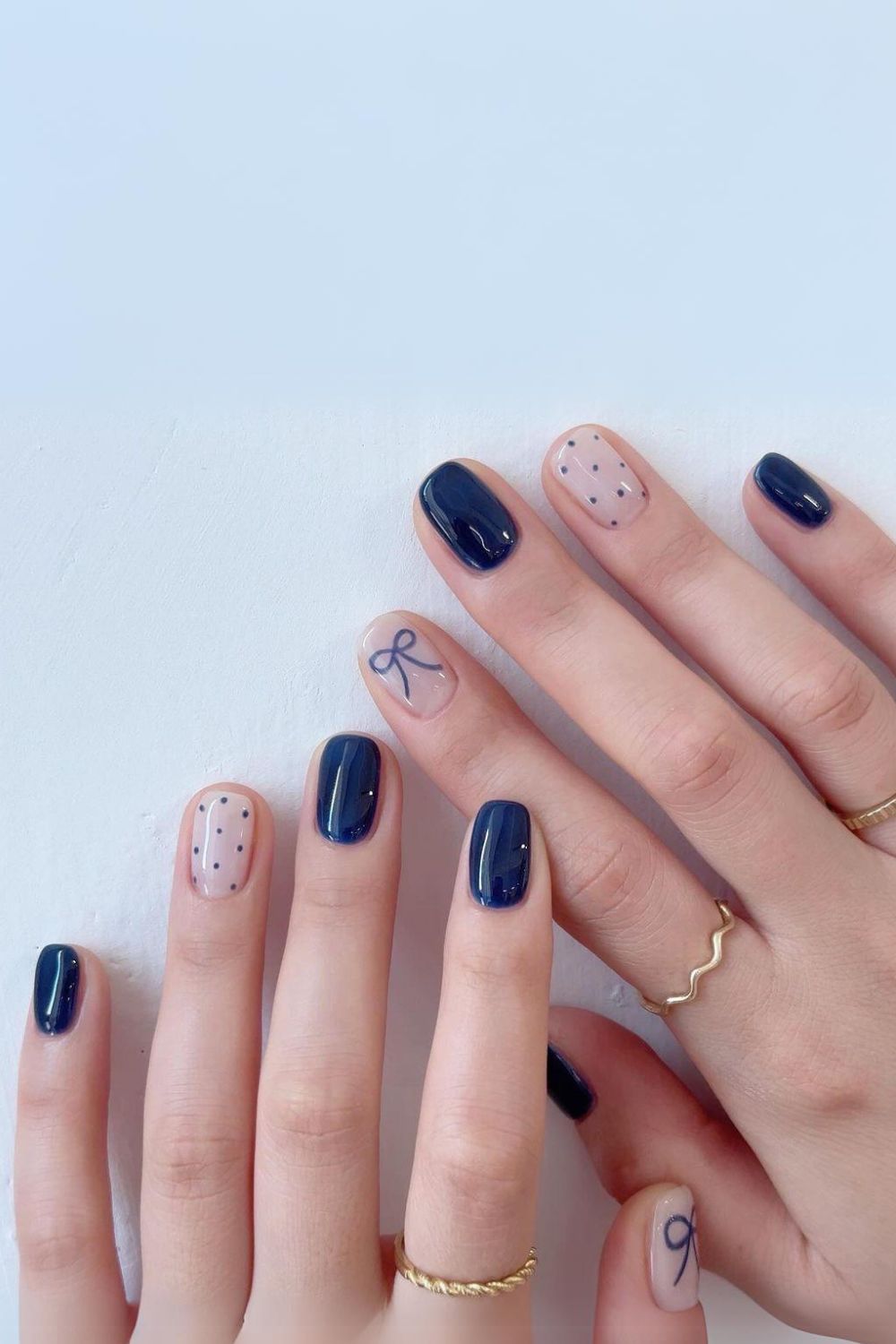 Navy blue coquette nails with bows and dots