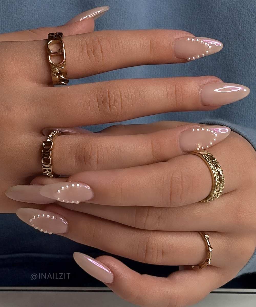 Neutral chrome nails with accent pearl French tips