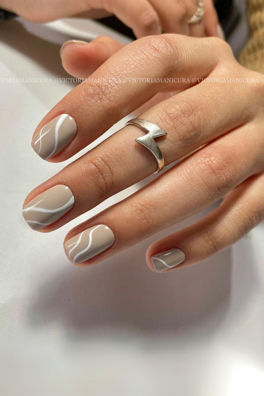 Neutral nails with white swirls