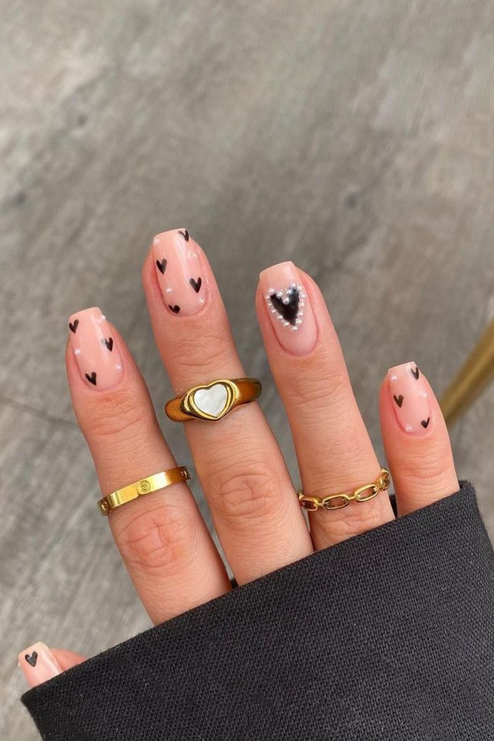 Nude nails with black hearts and 3d pearls