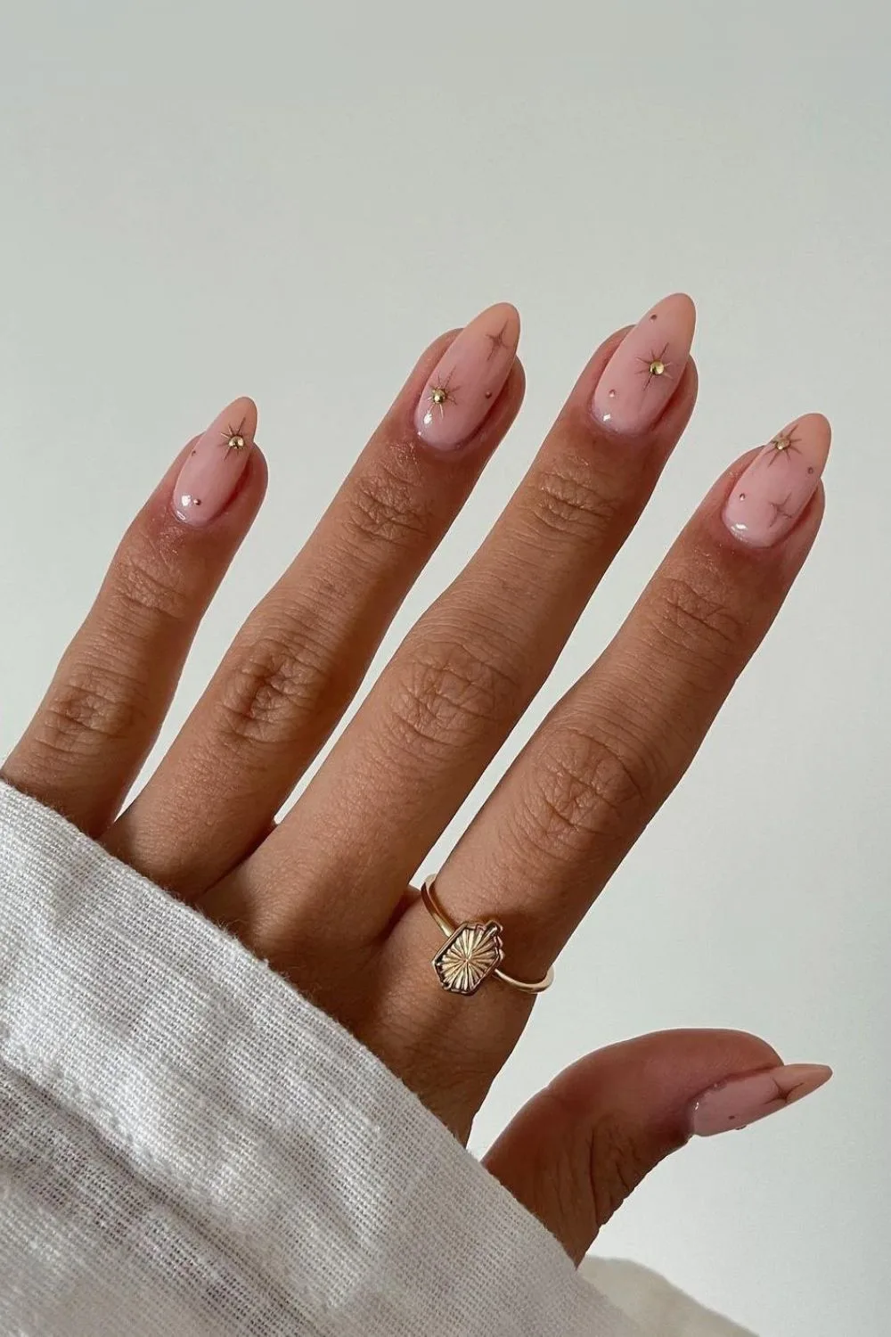 Nude nails with gold chrome stars