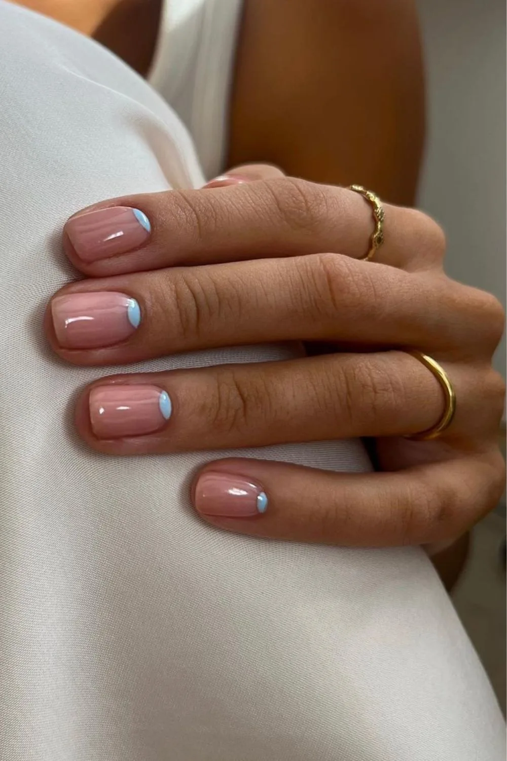 Nude nails with light blue half moon design