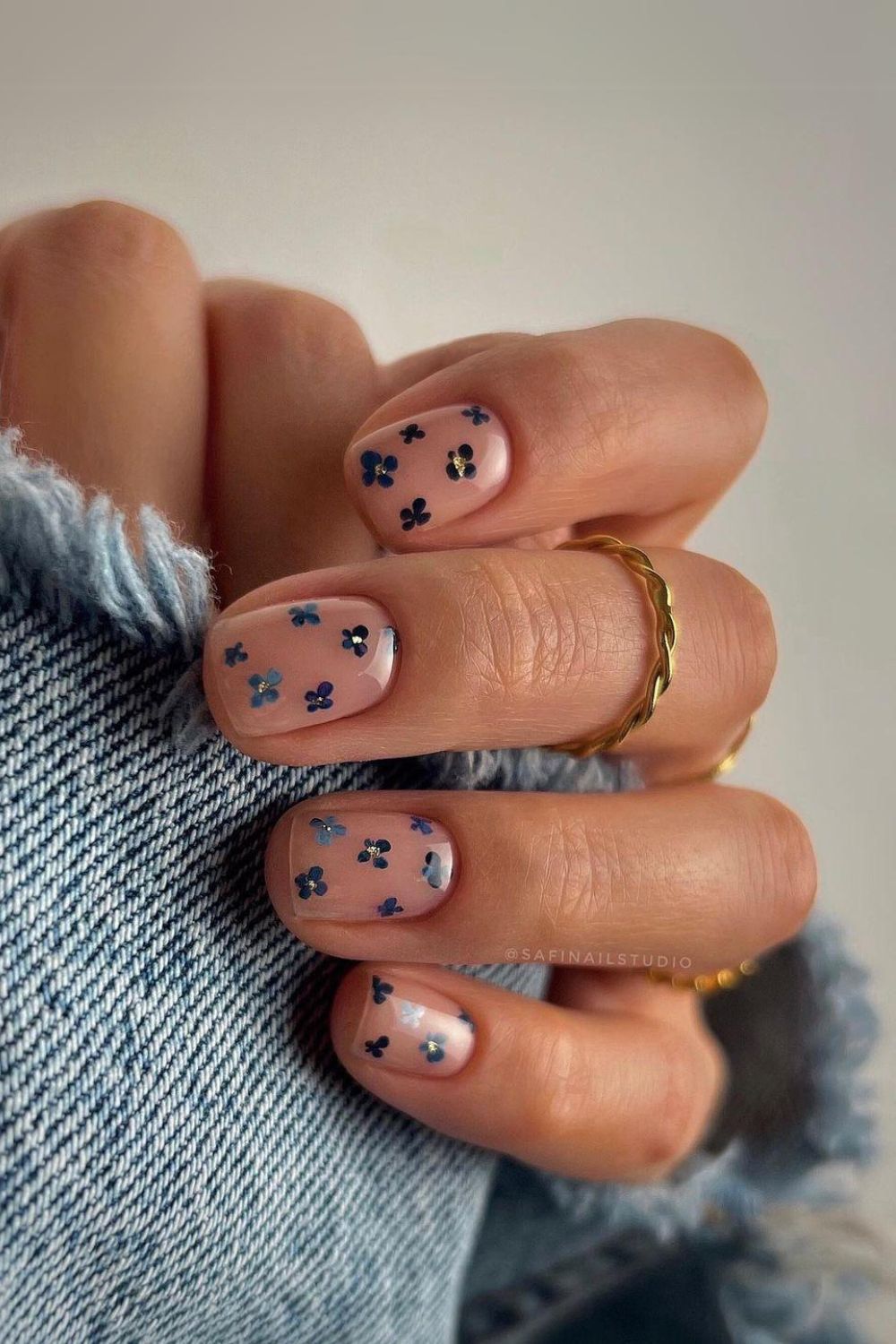 Nude nails with tiny blue flowers