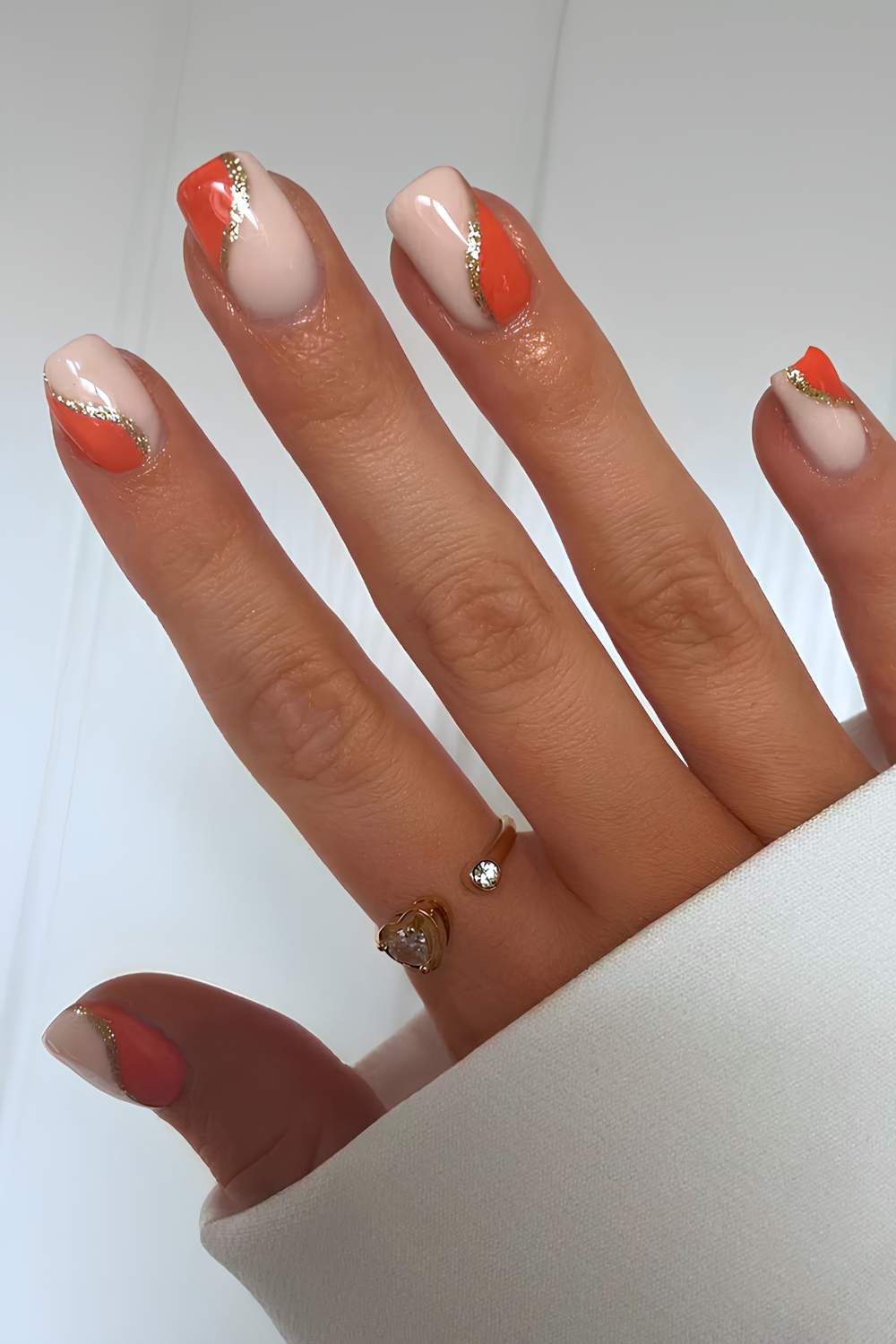 Orange and white fall nails with glitter