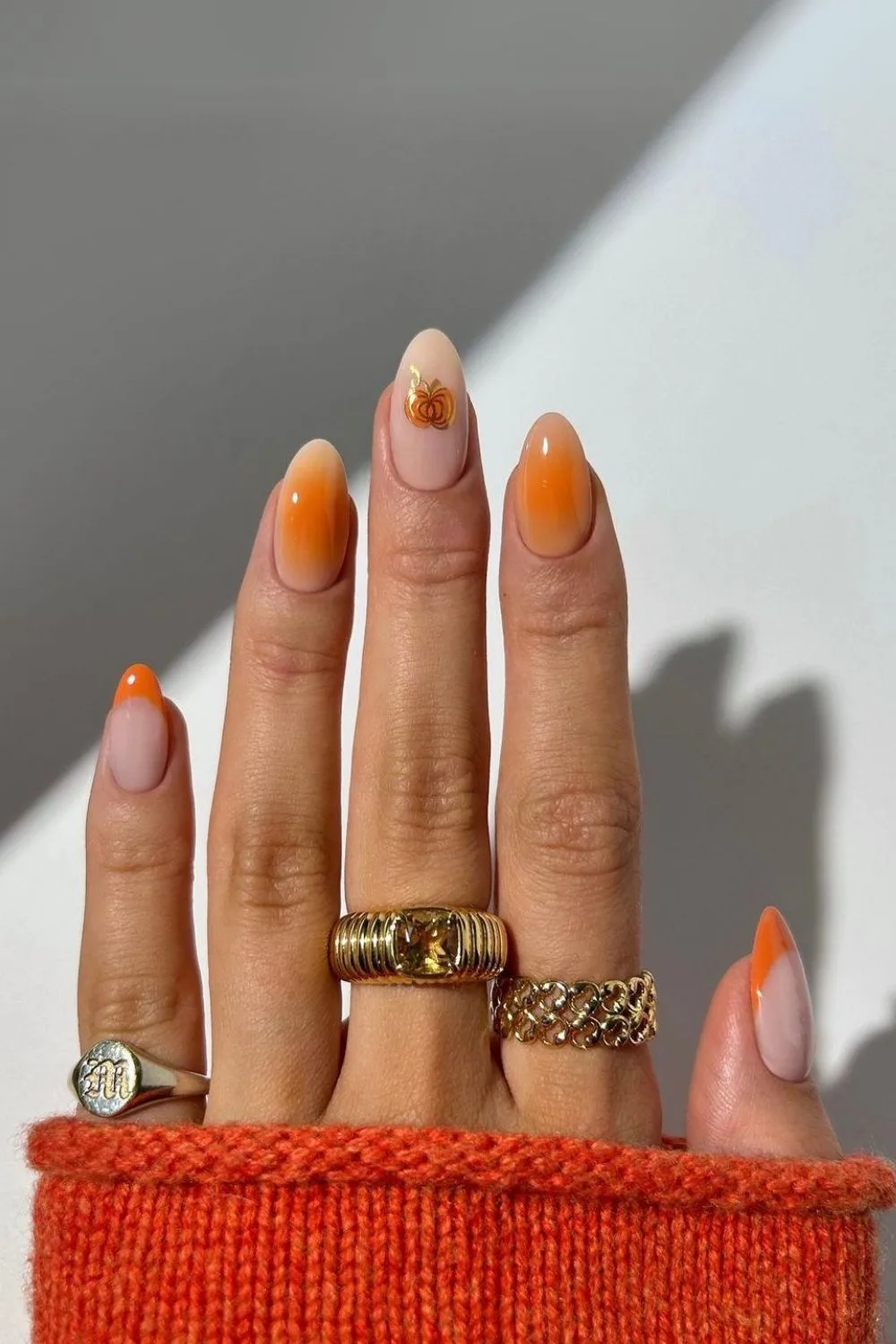 Orange nails with little pumpkin design