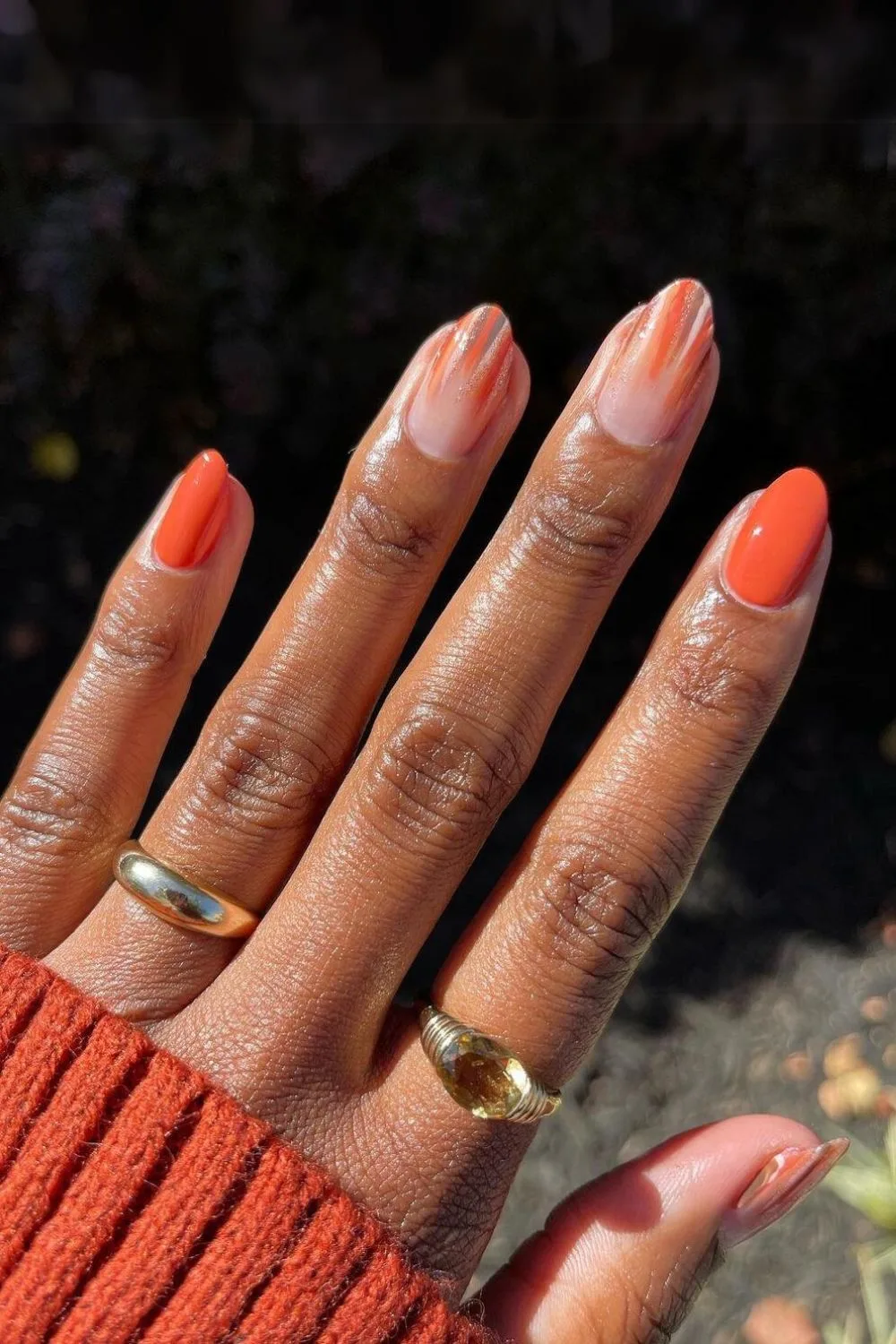 Orange nails with stripe and glitter accent