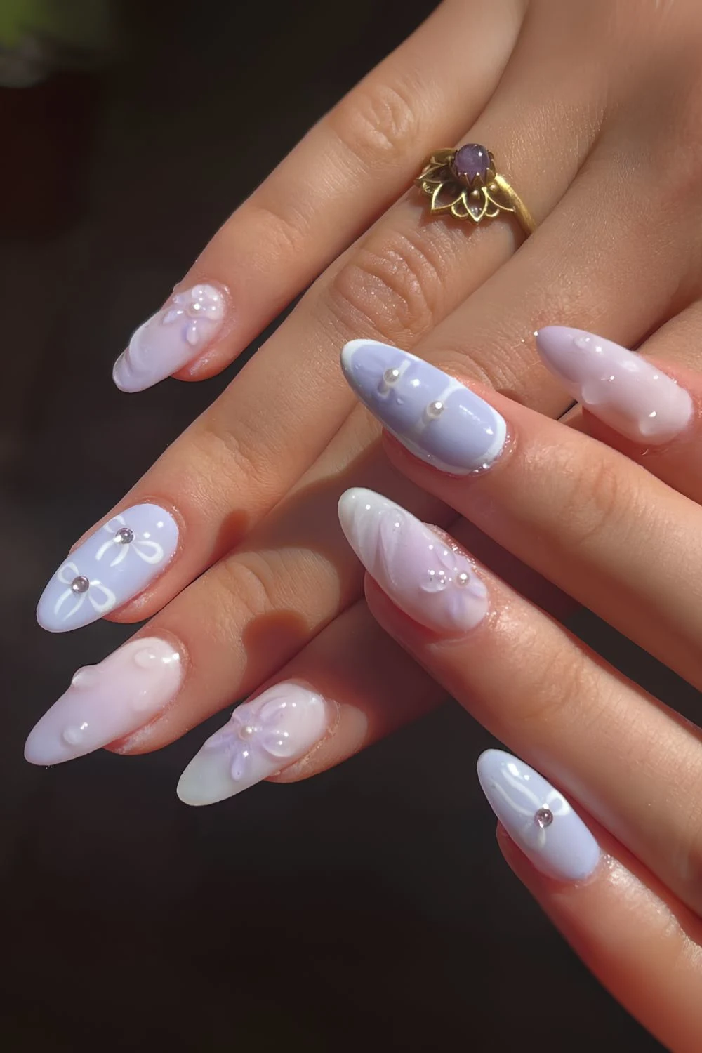 Pale blue nails with tiny pearls and bows
