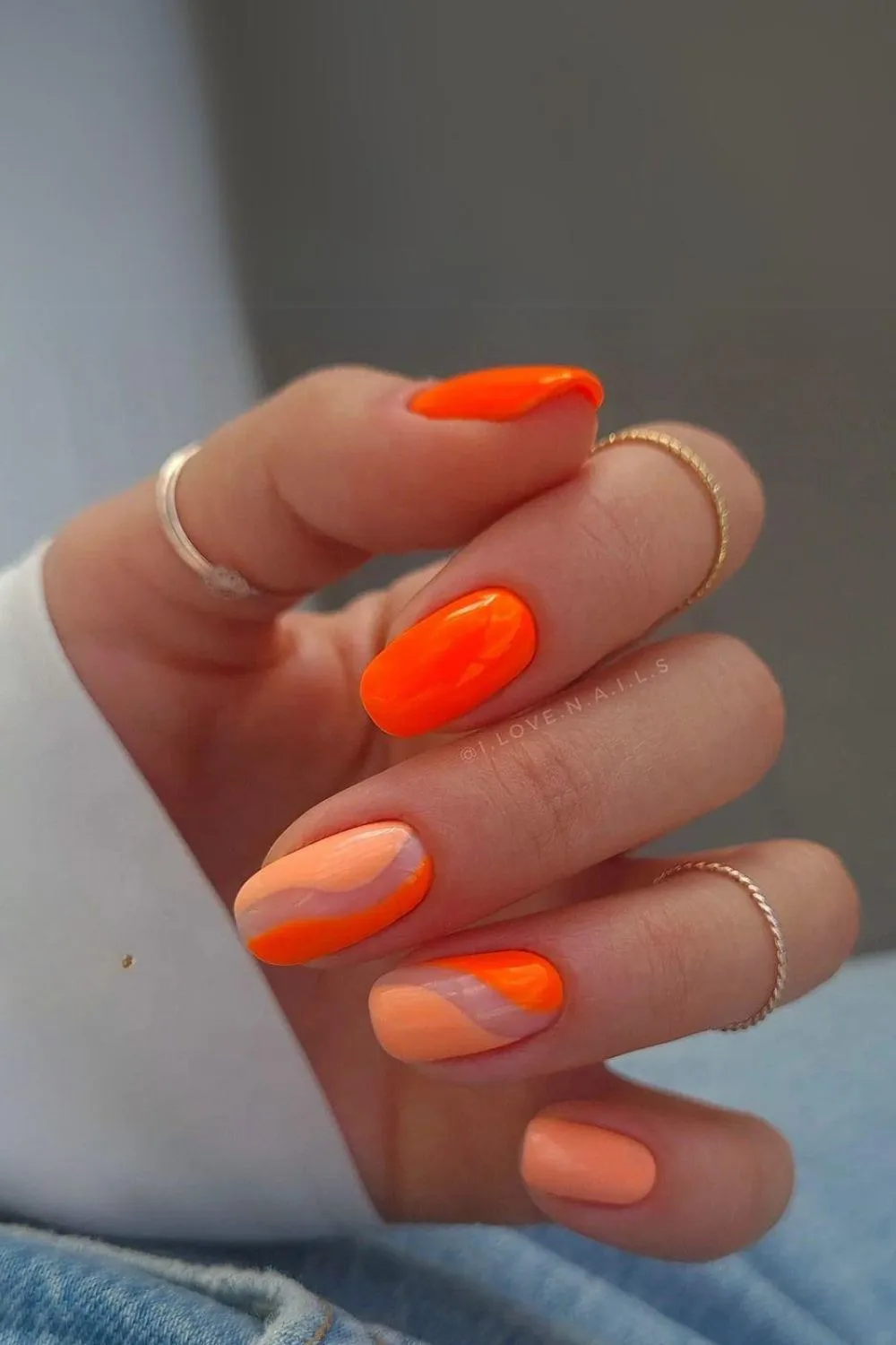 Peach and orange nails with negative space design