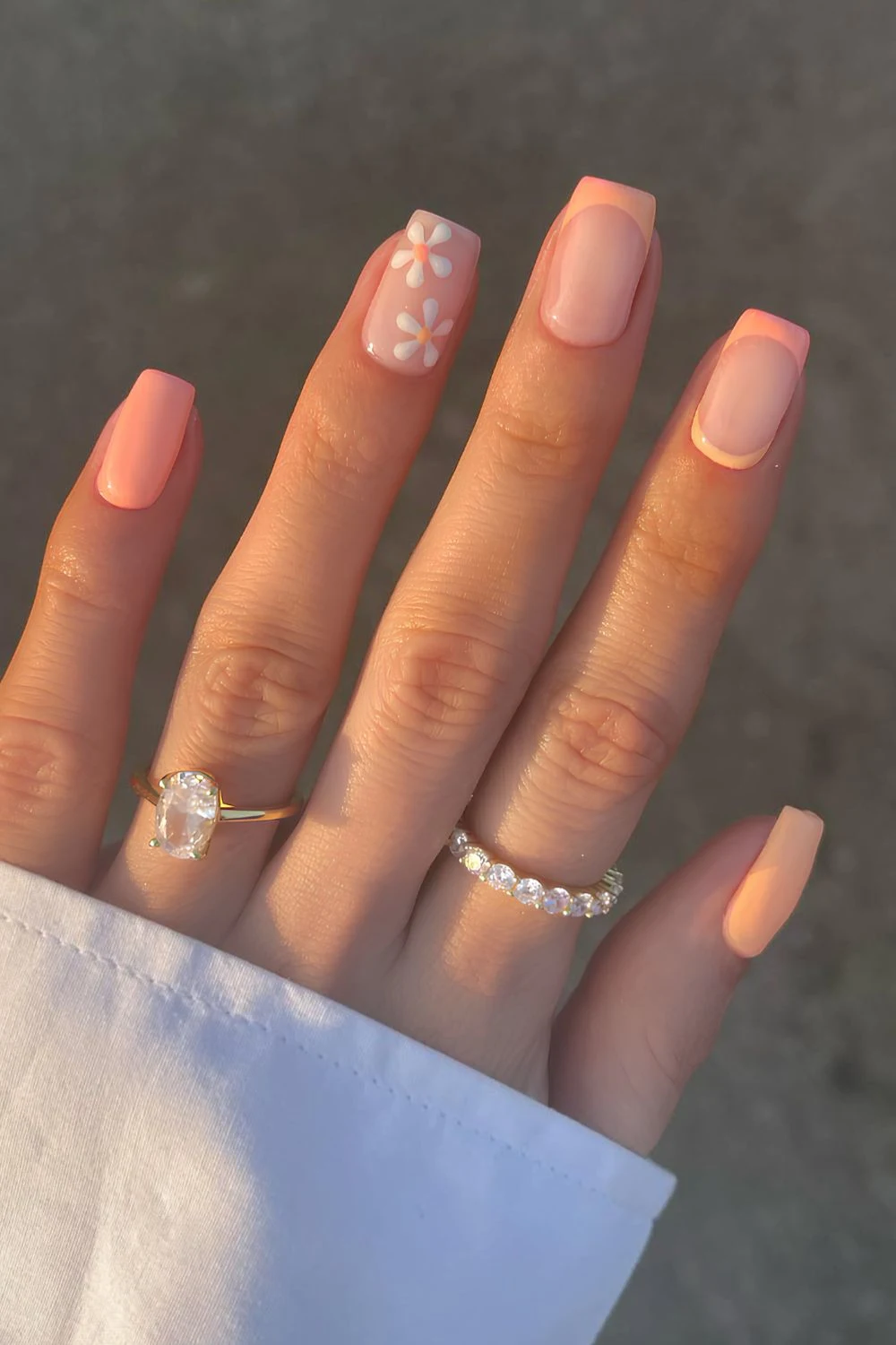 Peach nails with tiny floral art