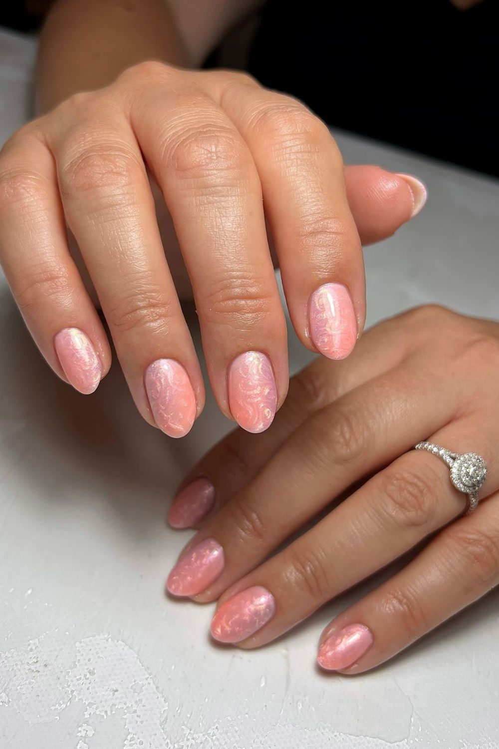 Peach pink nails with pearl-swirl finish