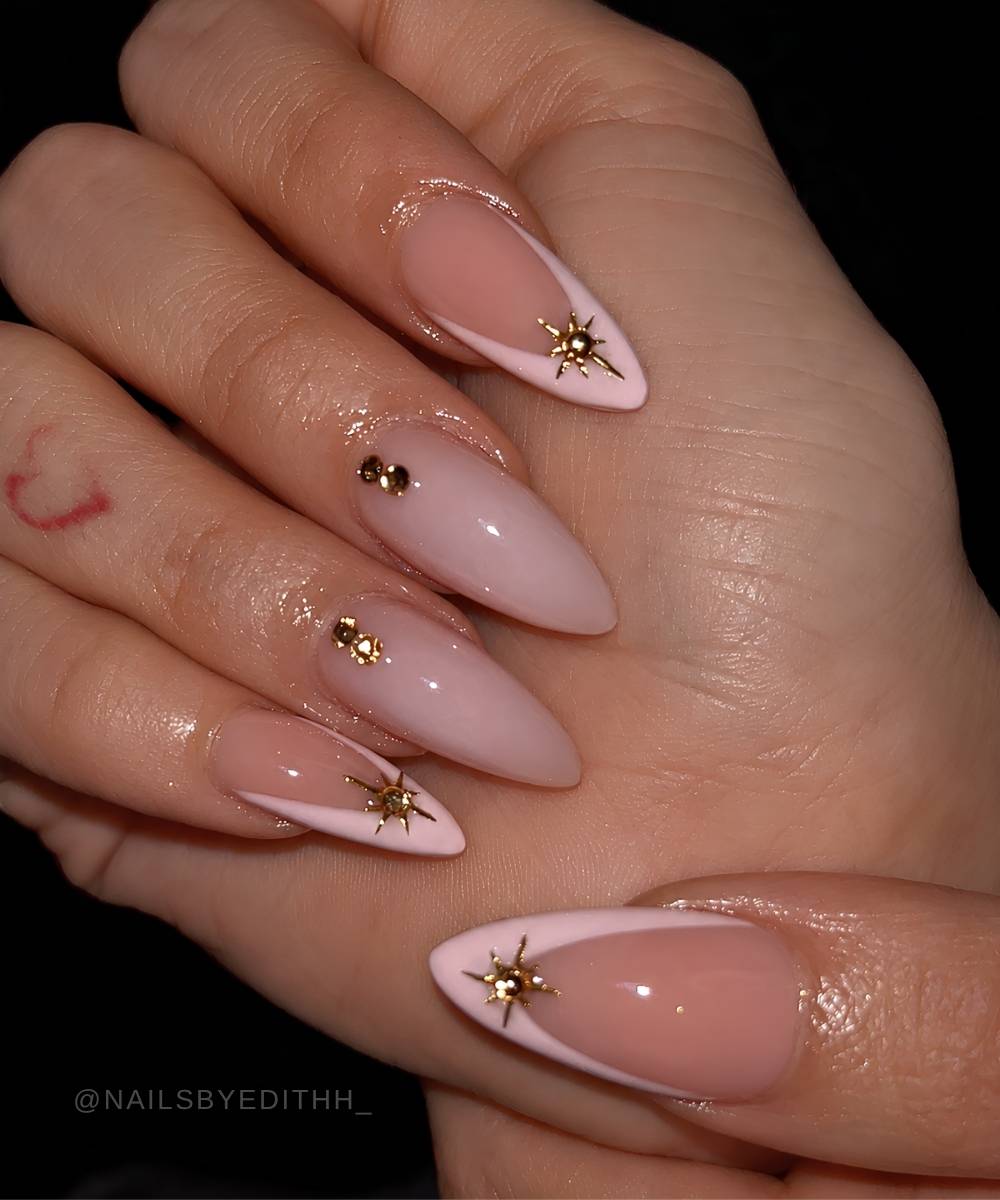 Pink French mani with gems and gold celestial art