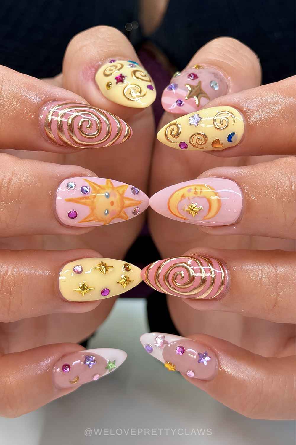 Pink and yellow nails with gems and celestial art