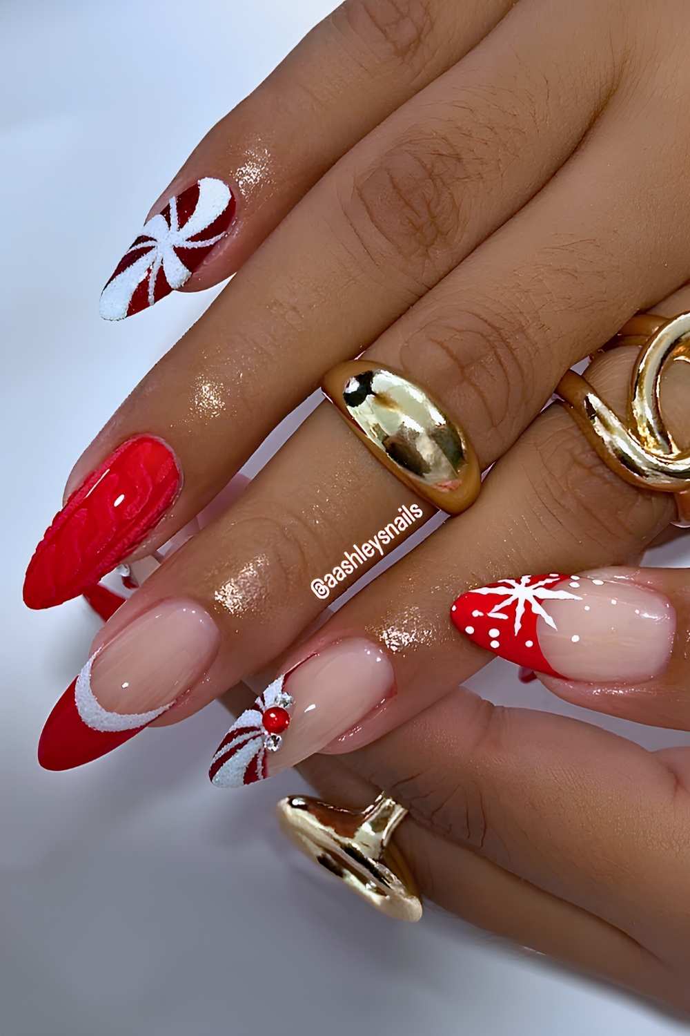 Red Christmas nails with sweater patterns and swirls