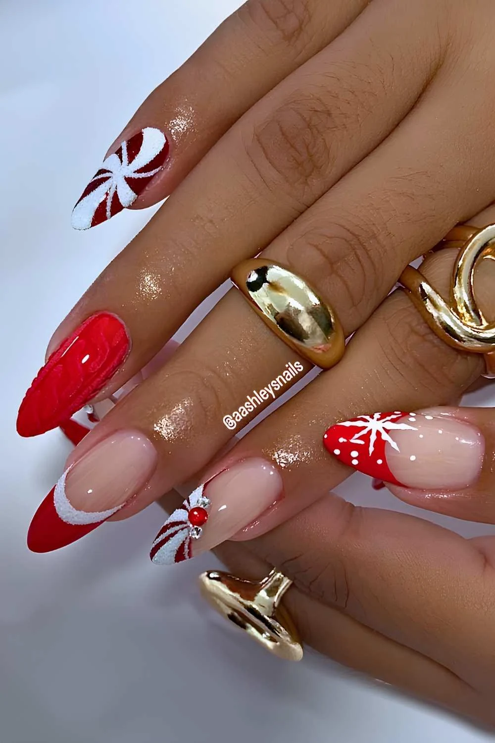 Red Christmas nails with sweater patterns and swirls