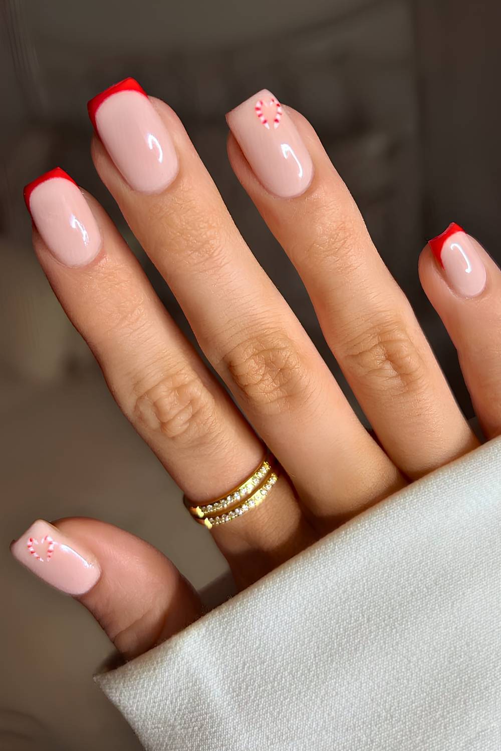 Red French mani with minimalist candy cane art