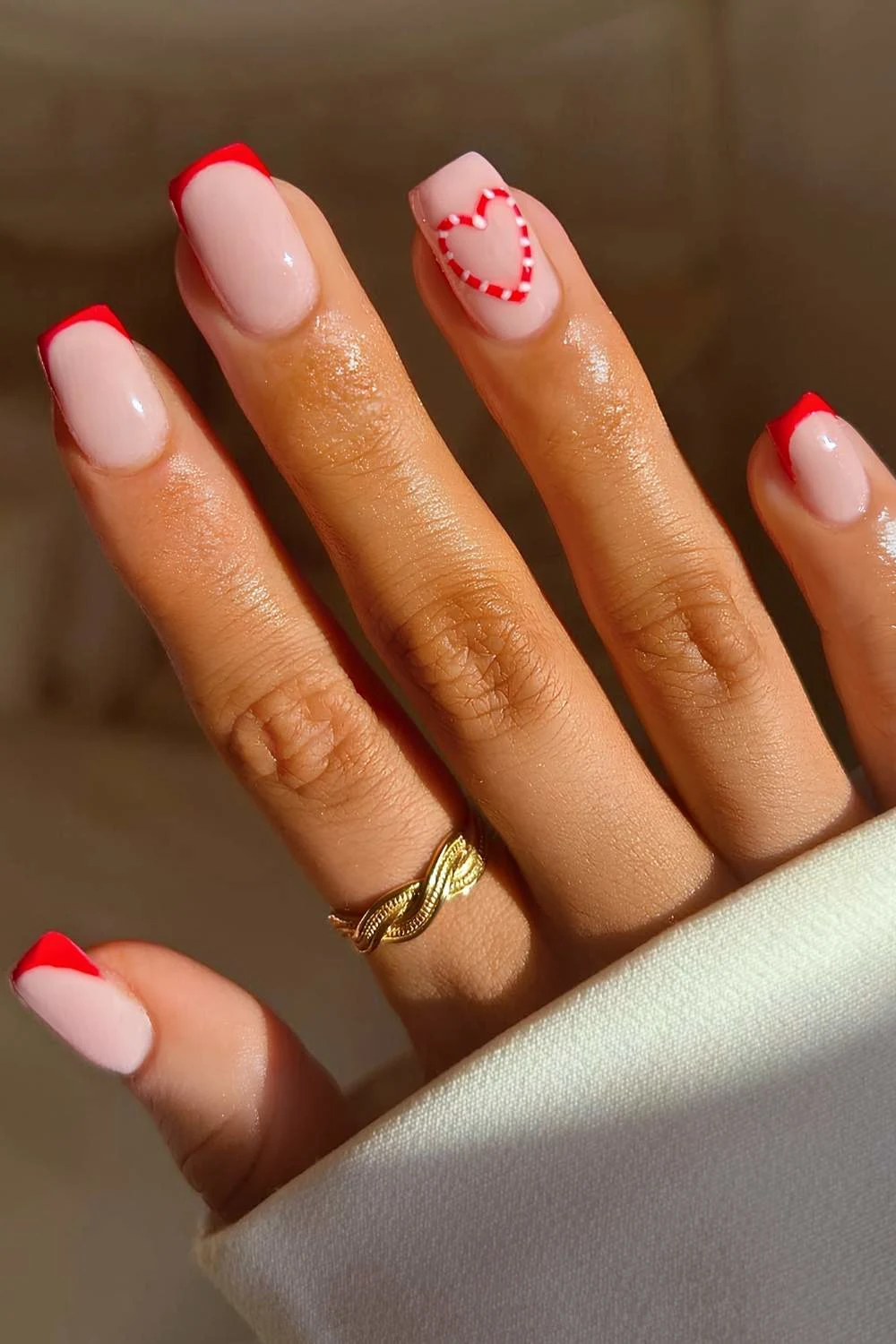 Red French manicure with candy cane heart art