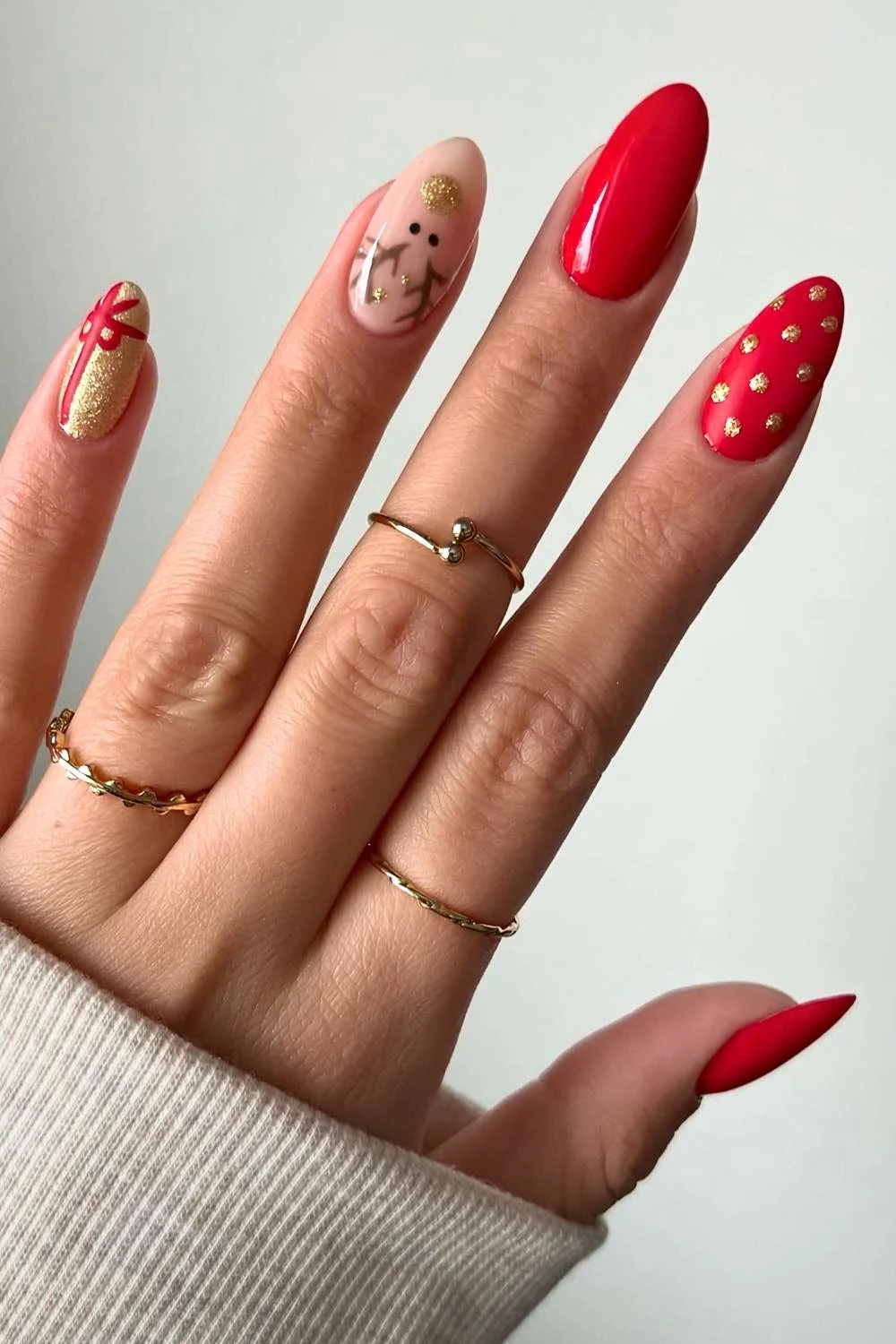 Red and gold nails with reindeer art