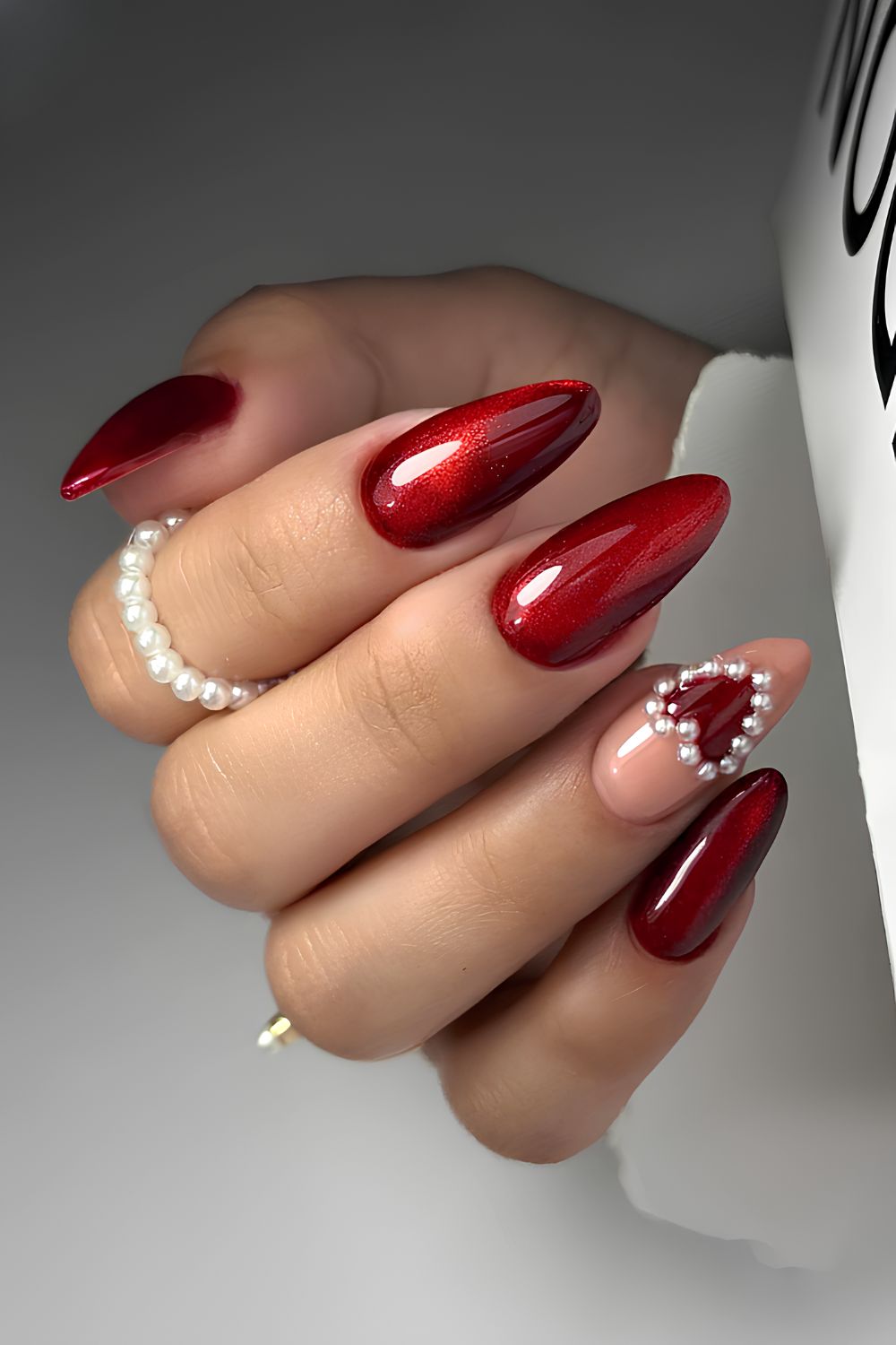 Red cat eye mani with pearl accents