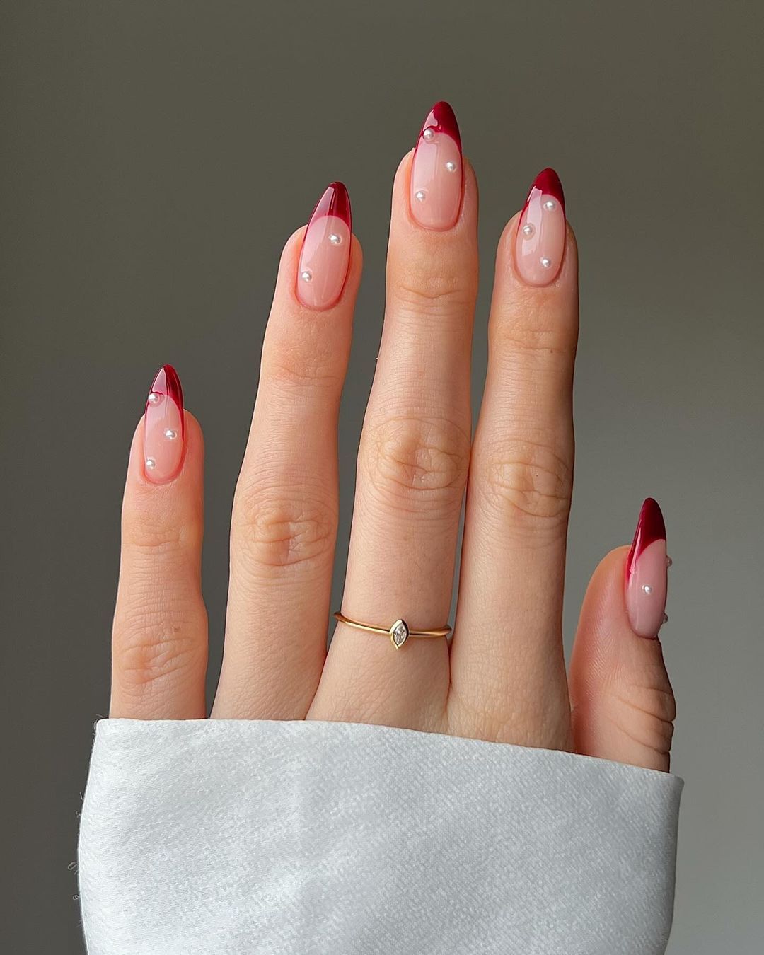 Red french manicure with white pearls