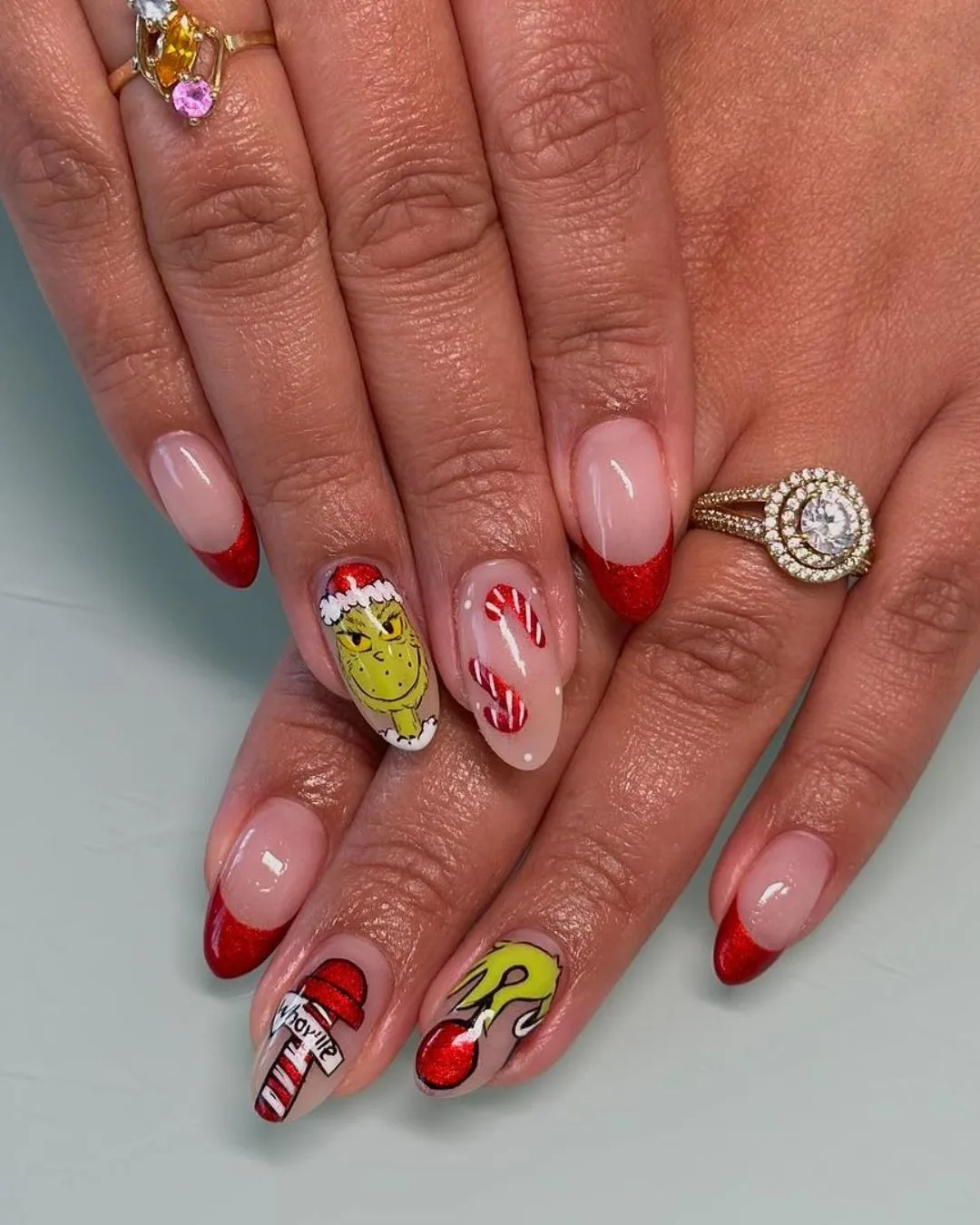 Red french tips with Grinch and candy cane nail art