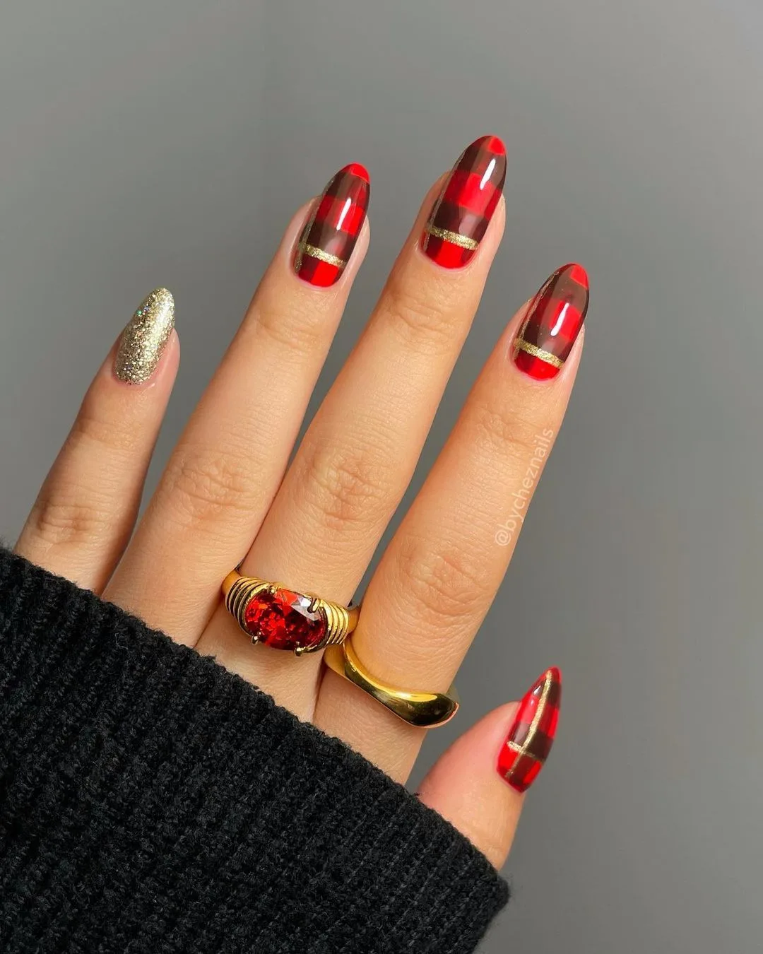 Red plaid nails with gold glitter accents