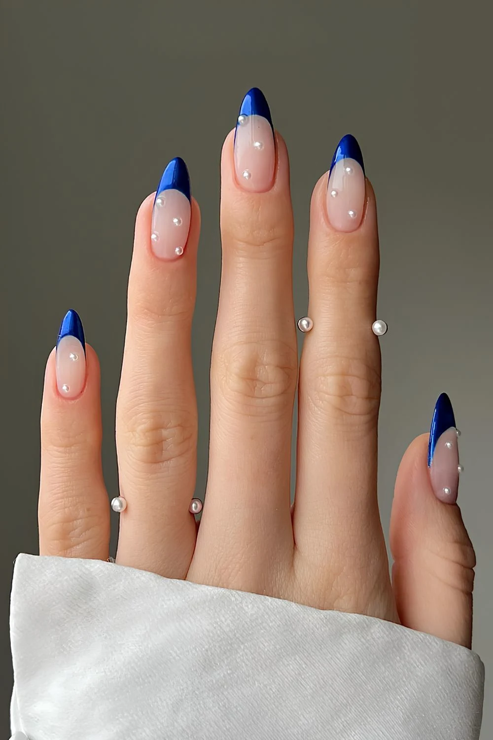 Sapphire blue French nails with accent pearls